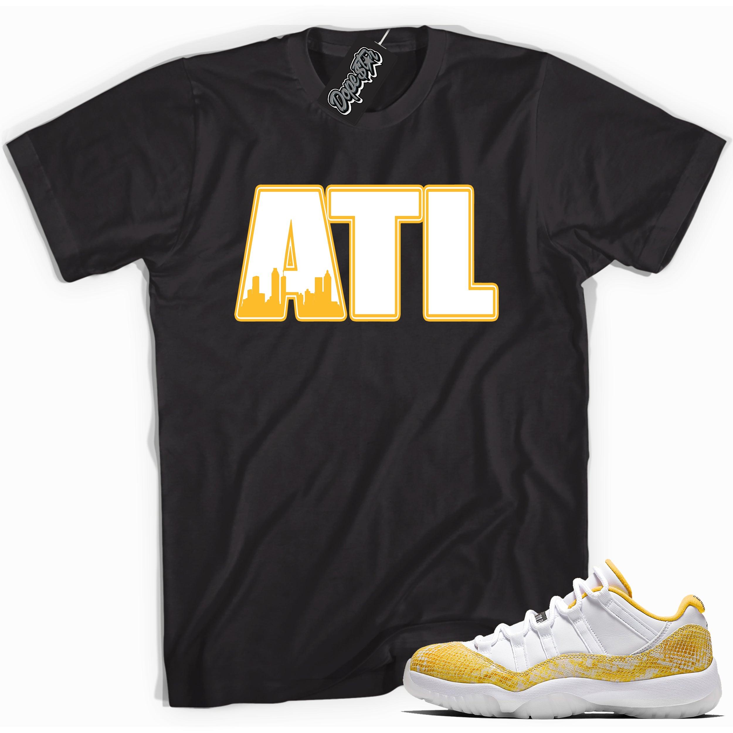 Cool black graphic tee with 'ATL' print, that perfectly matches Air Jordan 11 Retro Low Yellow Snakeskin sneakers
