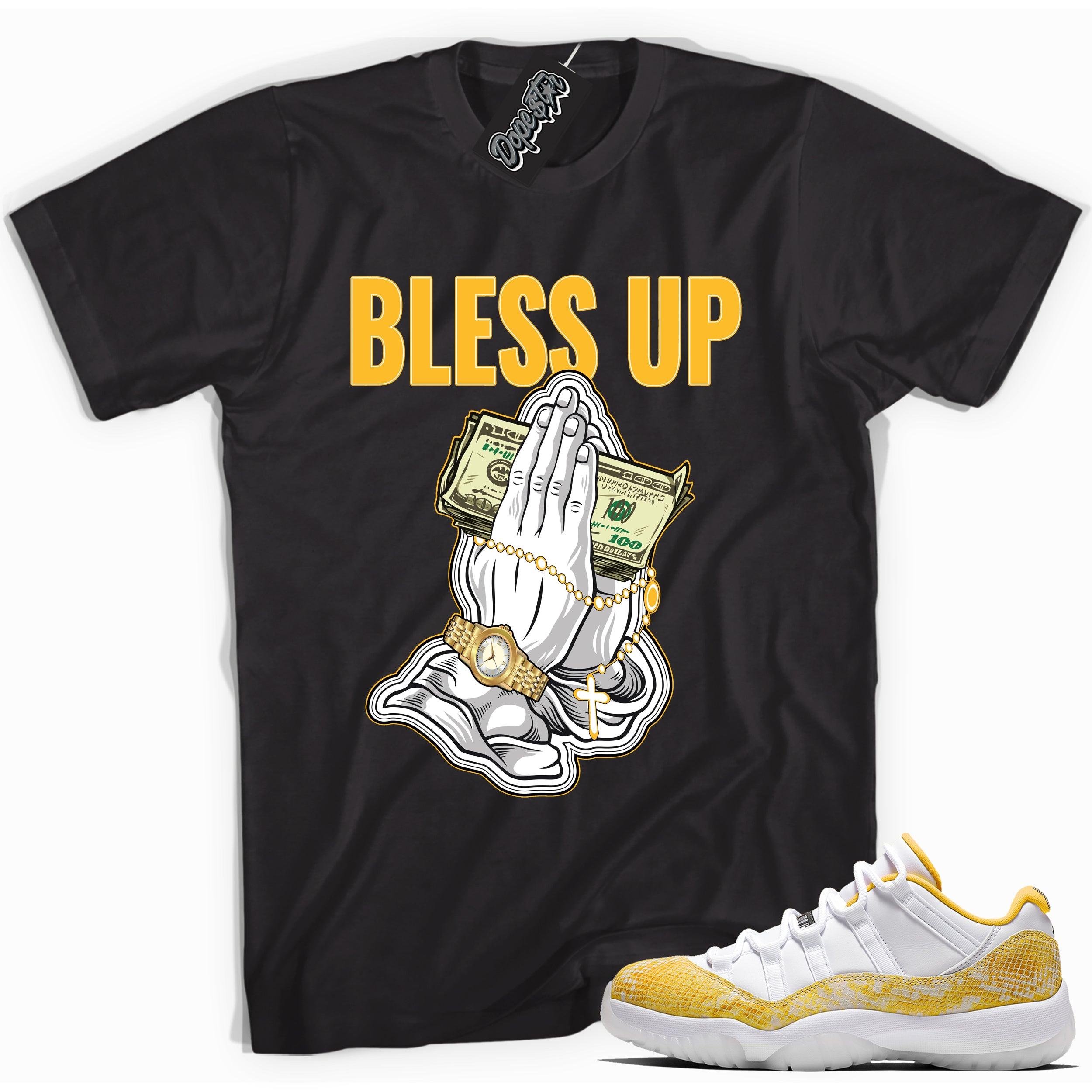 Cool black graphic tee with 'bless up' print, that perfectly matches Air Jordan 11 Retro Low Yellow Snakeskin sneakers