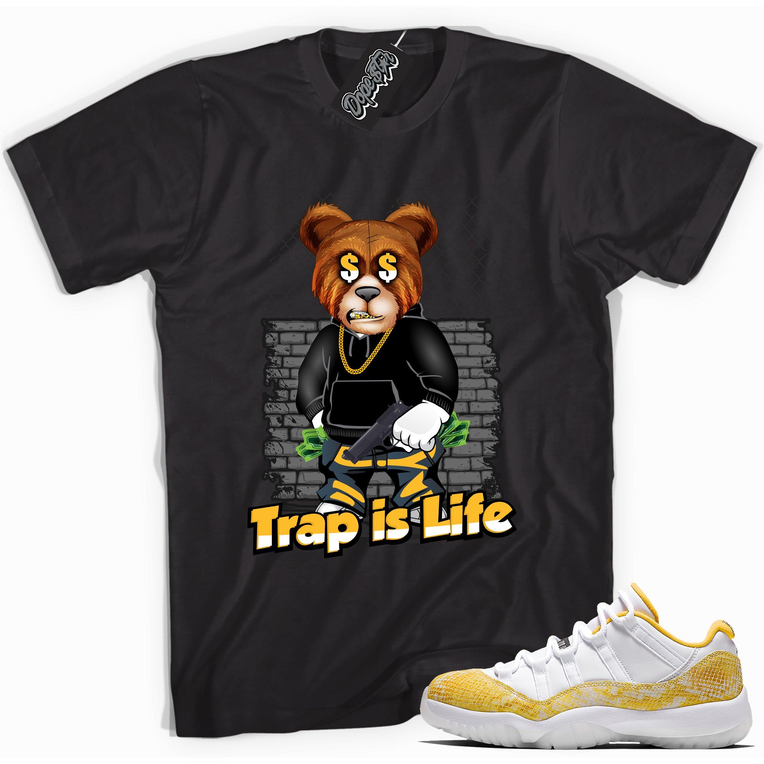Cool black graphic tee with 'trap is life' print, that perfectly matches Air Jordan 11 Retro Low Yellow Snakeskin sneakers