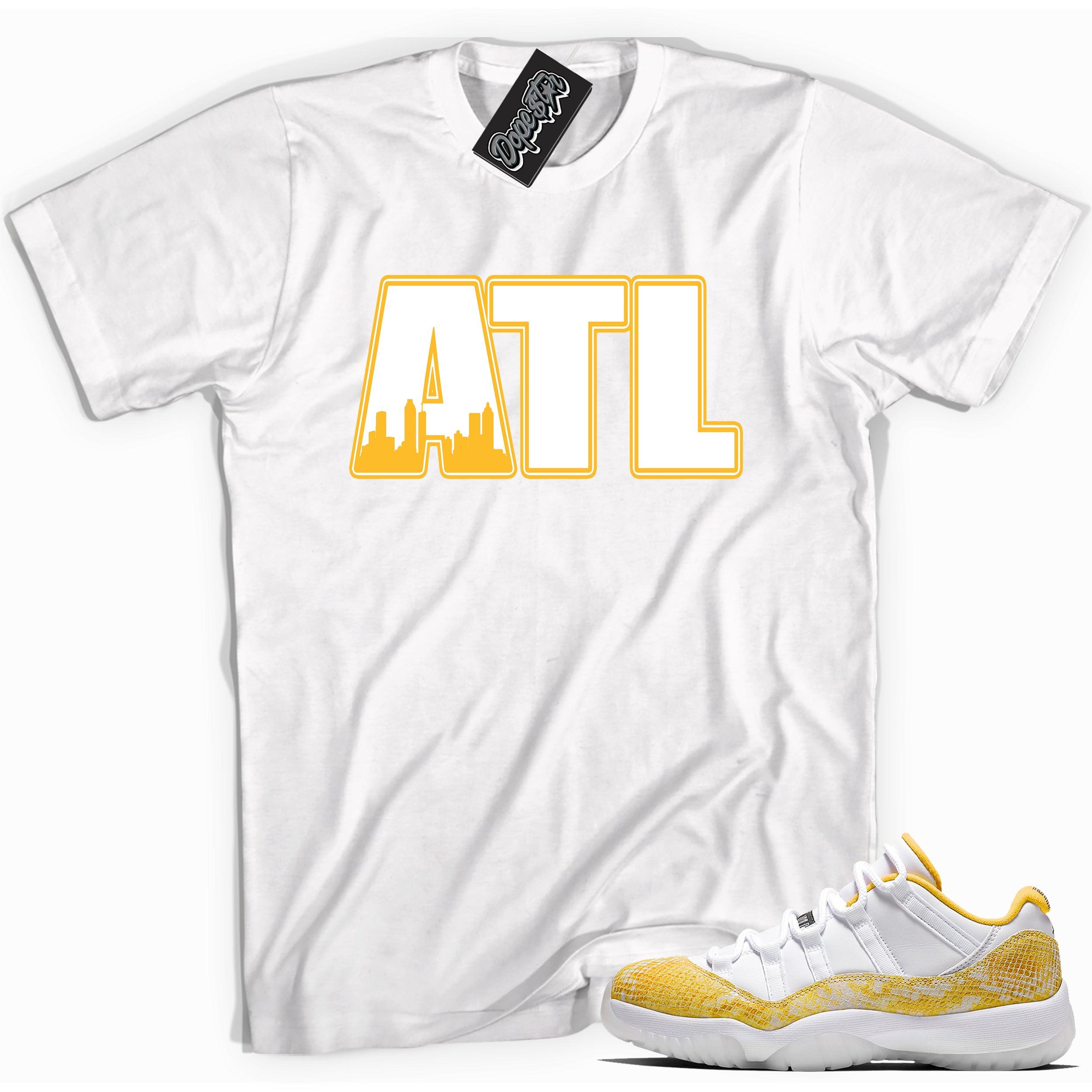 Cool white graphic tee with 'ATL' print, that perfectly matches Air Jordan 11 Retro Low Yellow Snakeskin sneakers