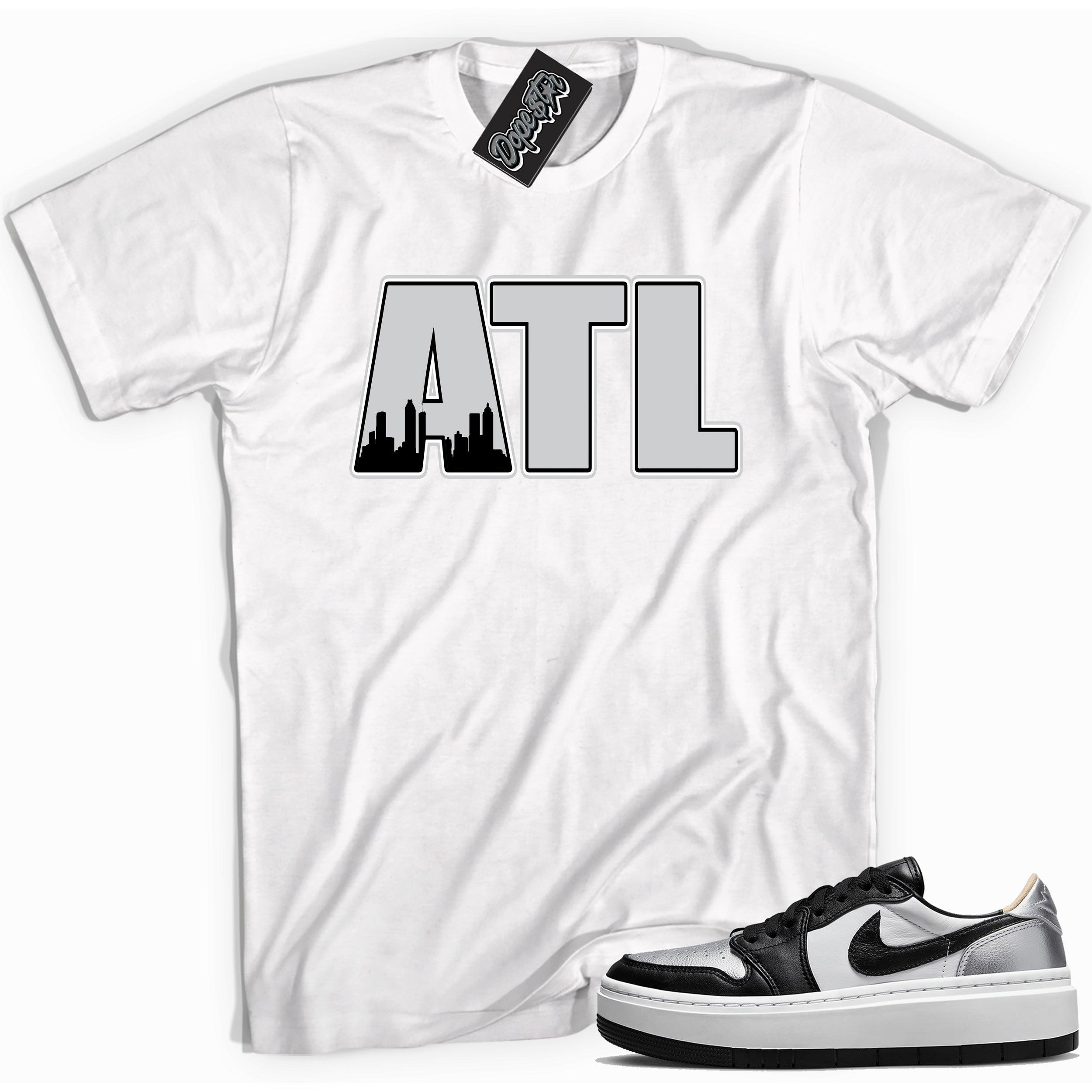 Cool white graphic tee with 'ATL Atlanta' print, that perfectly matches Air Jordan 1 Elevate Low SE Silver Toe sneakers.