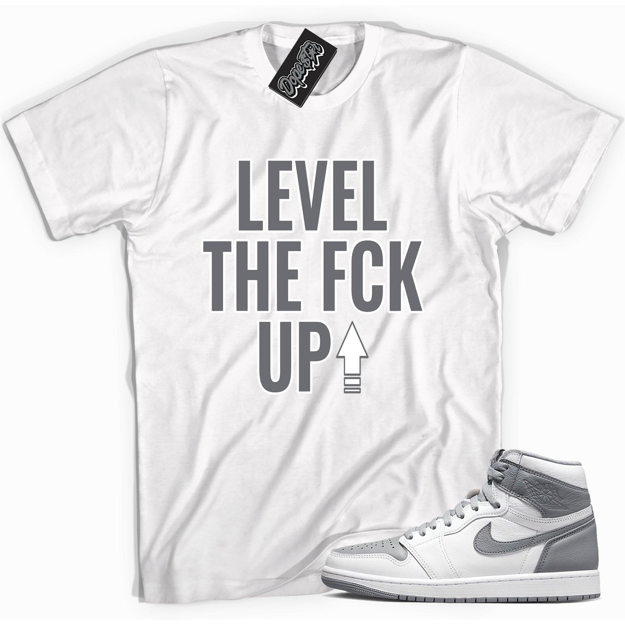 Cool white graphic tee with 'Level Up' print, that perfectly matches Air Jordan 1 High OG Stealth sneakers.