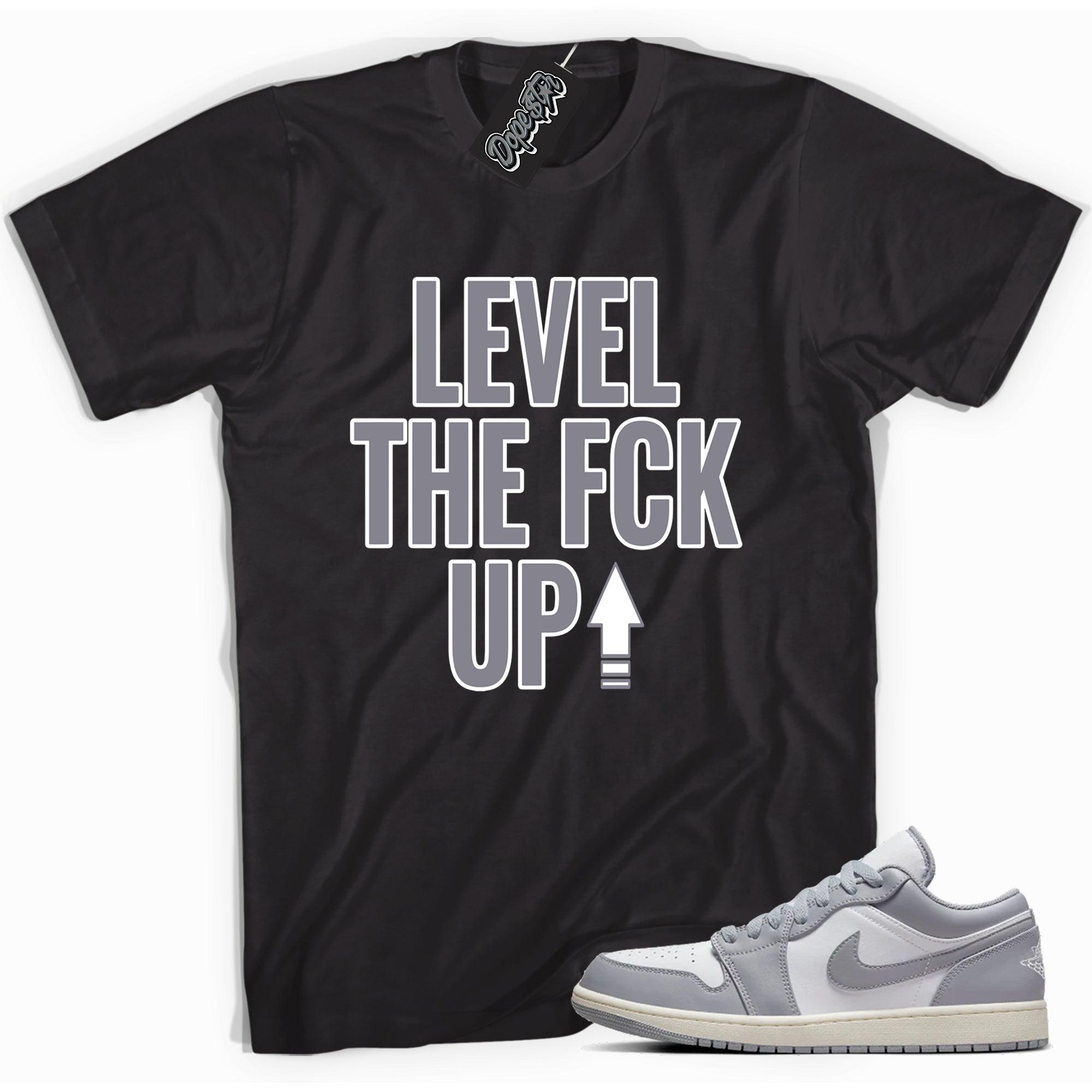 Cool black graphic tee with 'Level Up' print, that perfectly matches Air Jordan 1 Low Vintage Stealth Grey sneakers.