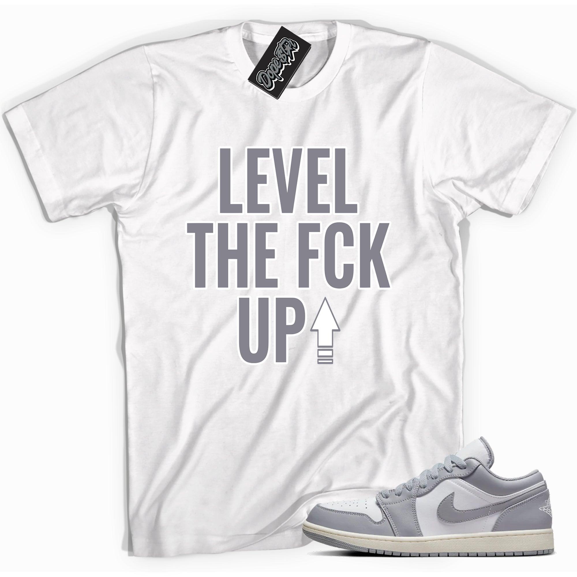 Cool white graphic tee with 'Level Up' print, that perfectly matches Air Jordan 1 Low Vintage Stealth Grey sneakers.