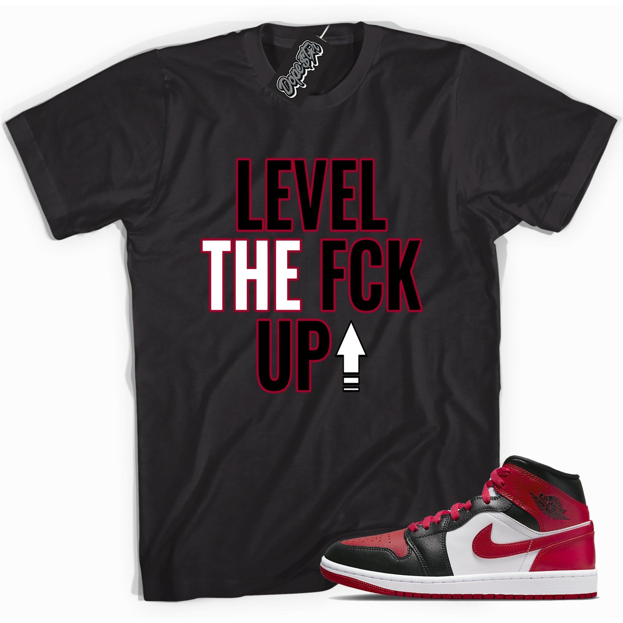 Cool black graphic tee with 'Level Up' print, that perfectly matches Air Jordan 1 Miid Alternate Bred Toe sneakers.
