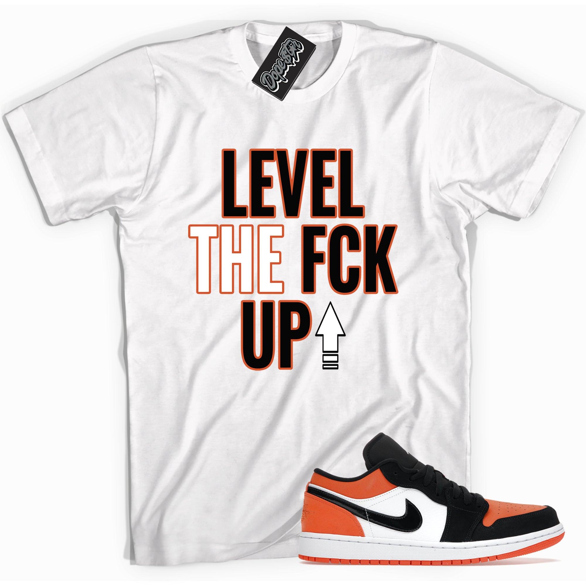 Cool white graphic tee with 'Level Up' print, that perfectly matches Air Jordan 1 Retro Low GolF Shattered Backboard sneakers.