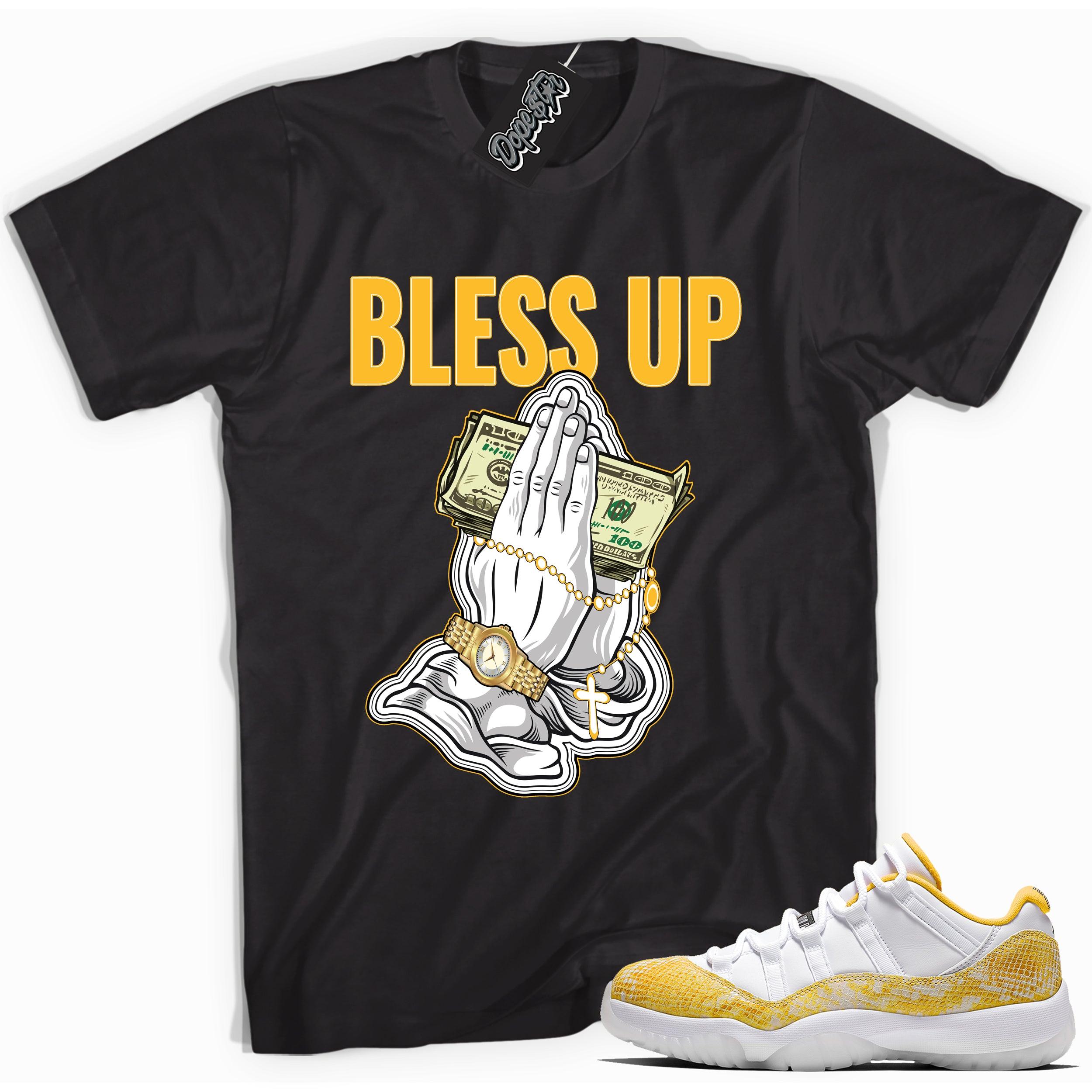 Cool black graphic tee with 'bless up' print, that perfectly matches  Air Jordan 11 Retro Low Yellow Snakeskin sneakers