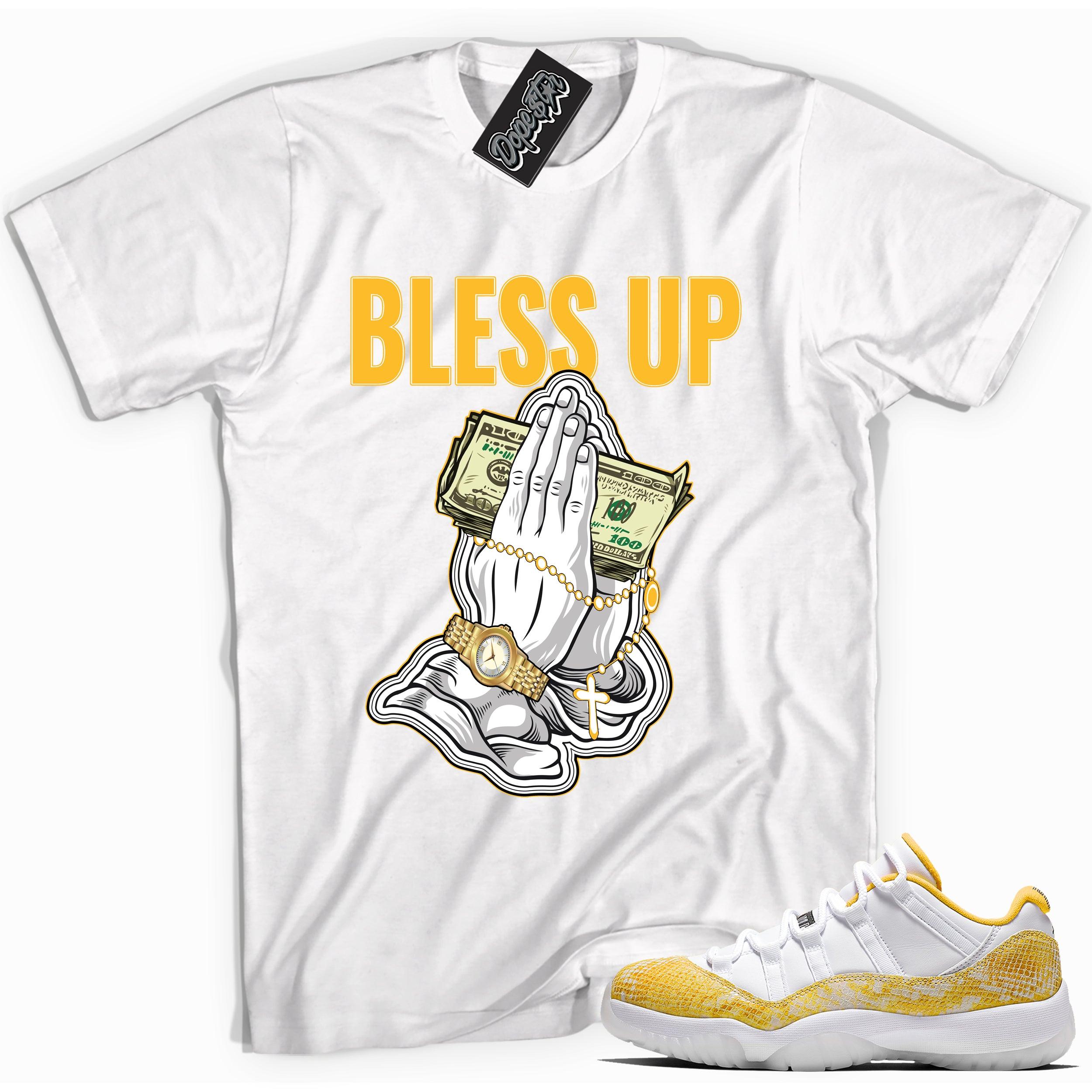 Cool white graphic tee with 'bless up' print, that perfectly matches Air Jordan 11 Retro Low Yellow Snakeskin sneakers