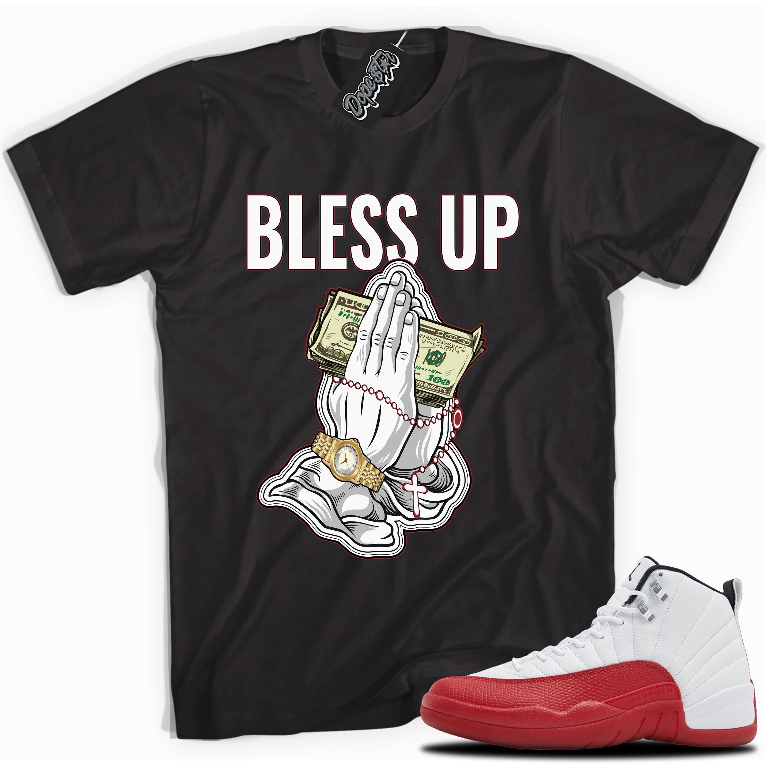 Cool Black graphic tee with “ Bless Up ” print, that perfectly matches Air Jordan 12 Retro Cherry Red 2023 red and white sneakers