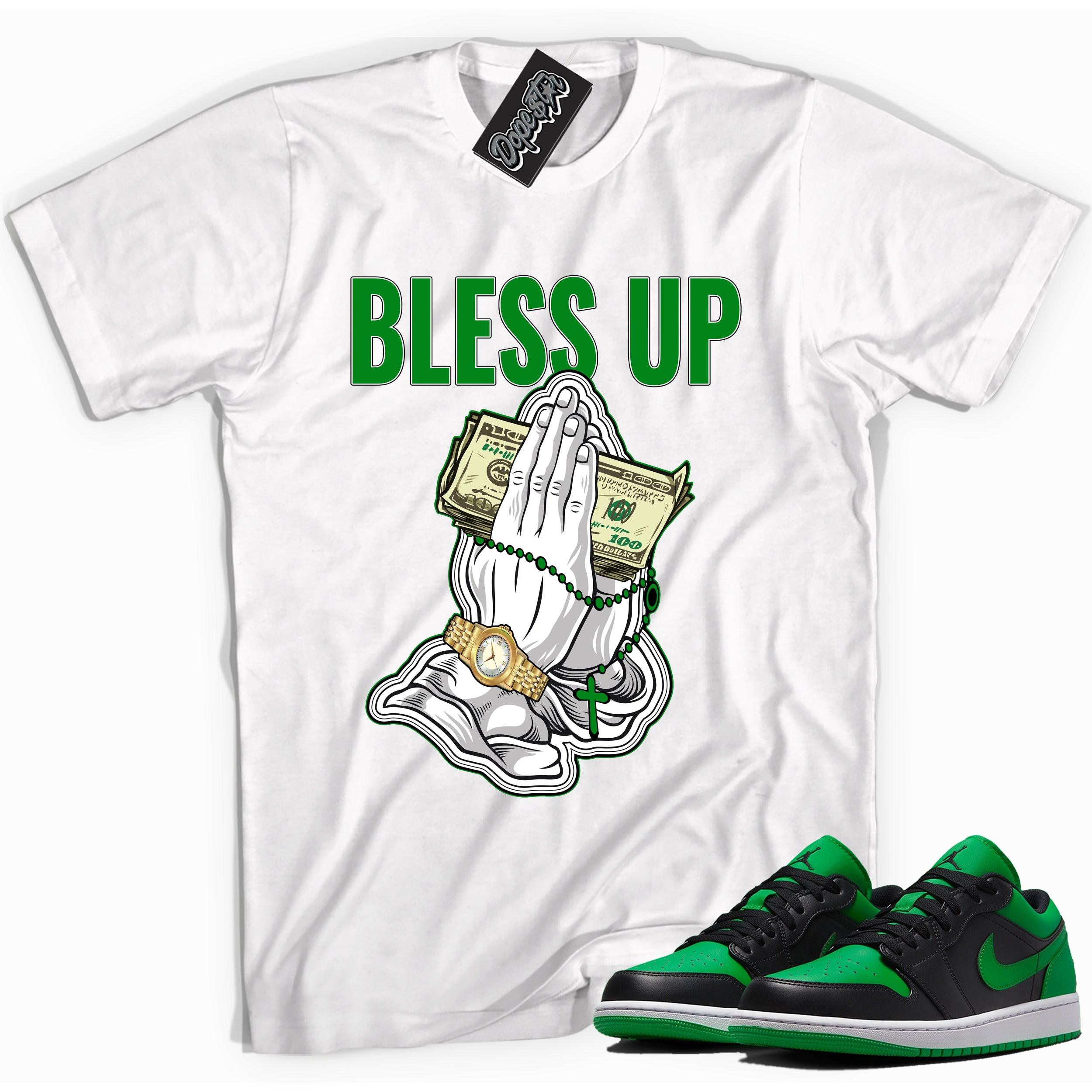 Cool white graphic tee with 'Bless Up' print, that perfectly matches Air Jordan 1 Low Lucky Green sneakers