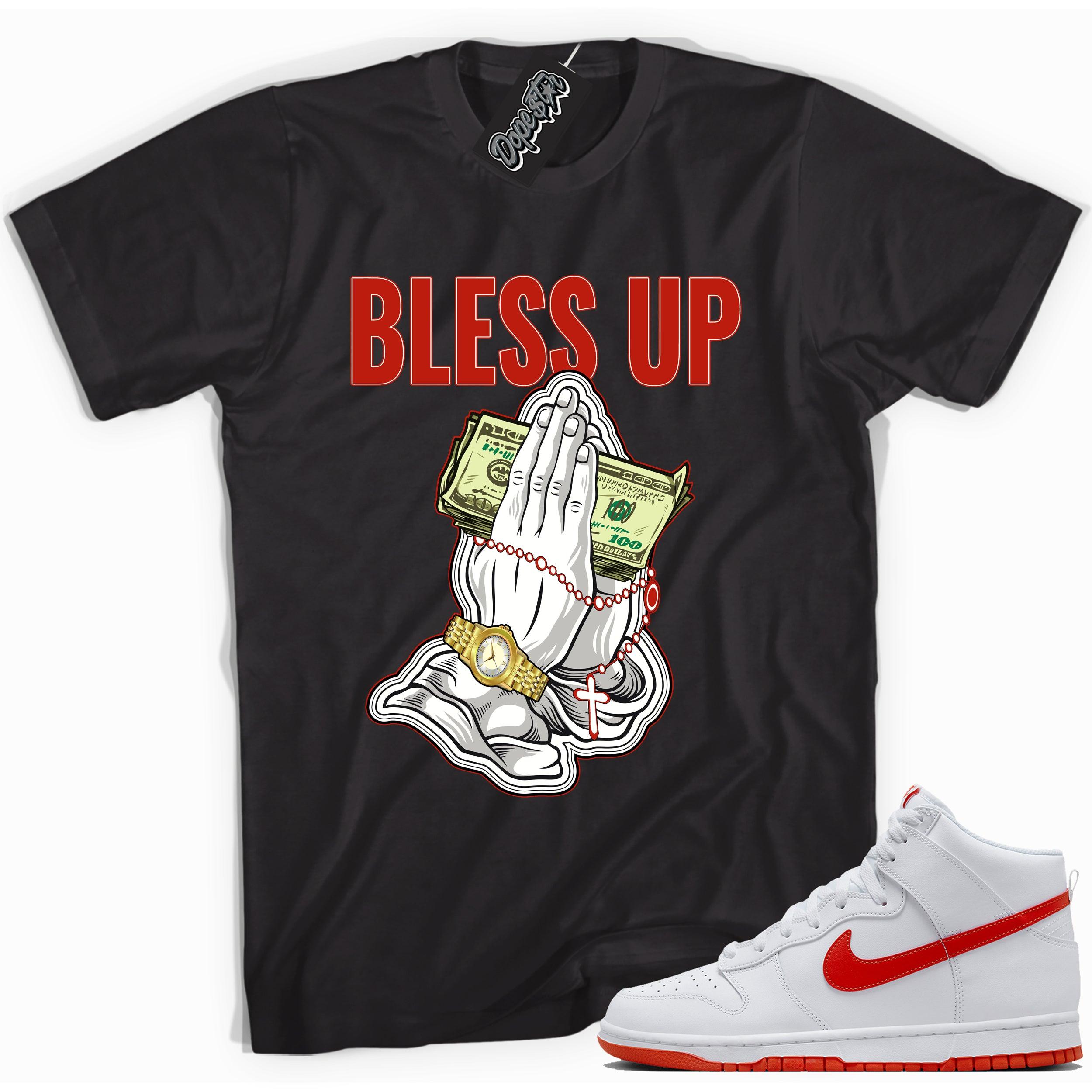 Cool black graphic tee with 'bless up praying hands' print, that perfectly matches Nike Dunk High White Picante Red sneakers.