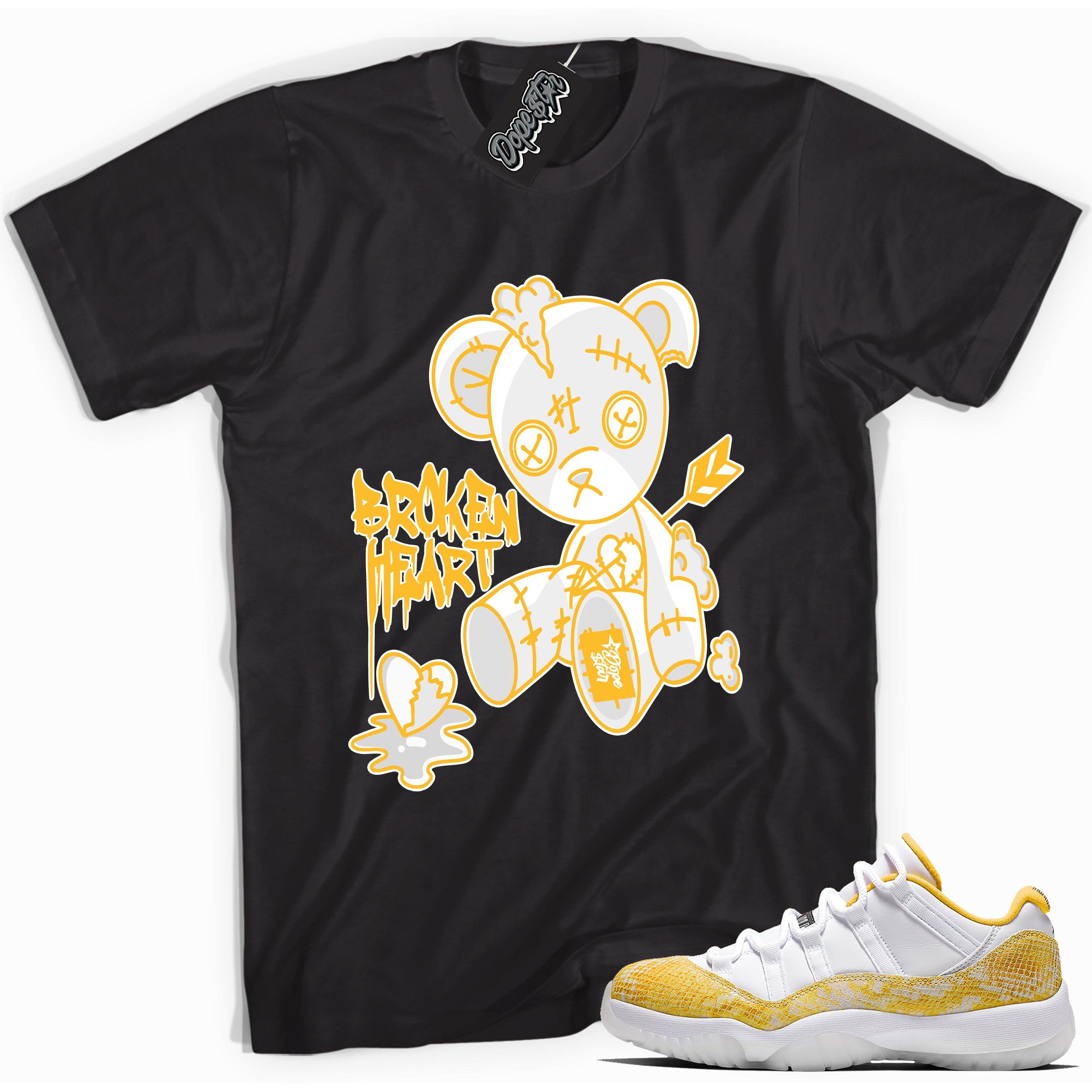 Cool black graphic tee with 'broken heart bear' print, that perfectly matches  Air Jordan 11 Low Yellow Snakeskin sneakers