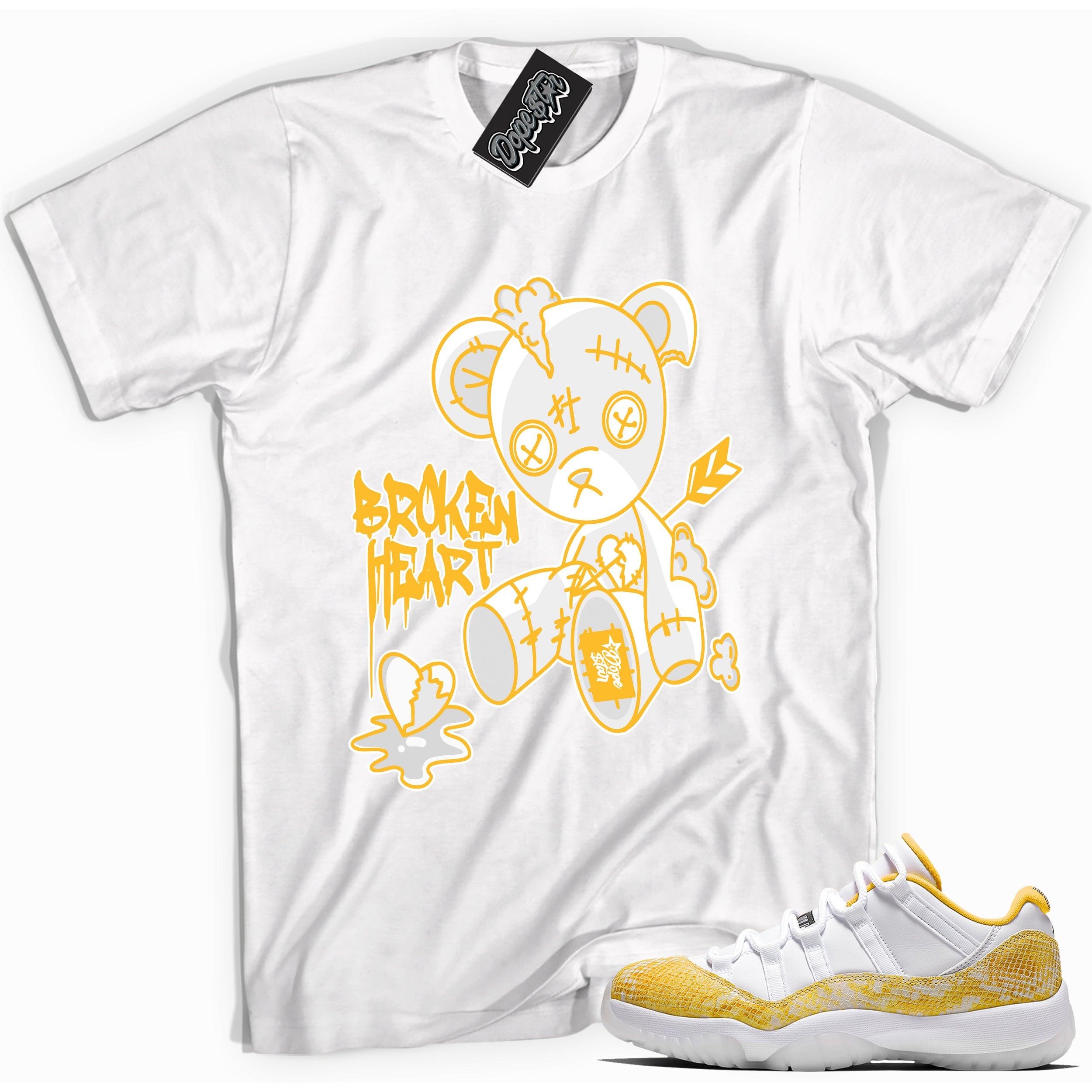 Cool white graphic tee with 'broken heart bear' print, that perfectly matches Air Jordan 11 Low Yellow Snakeskin sneakers