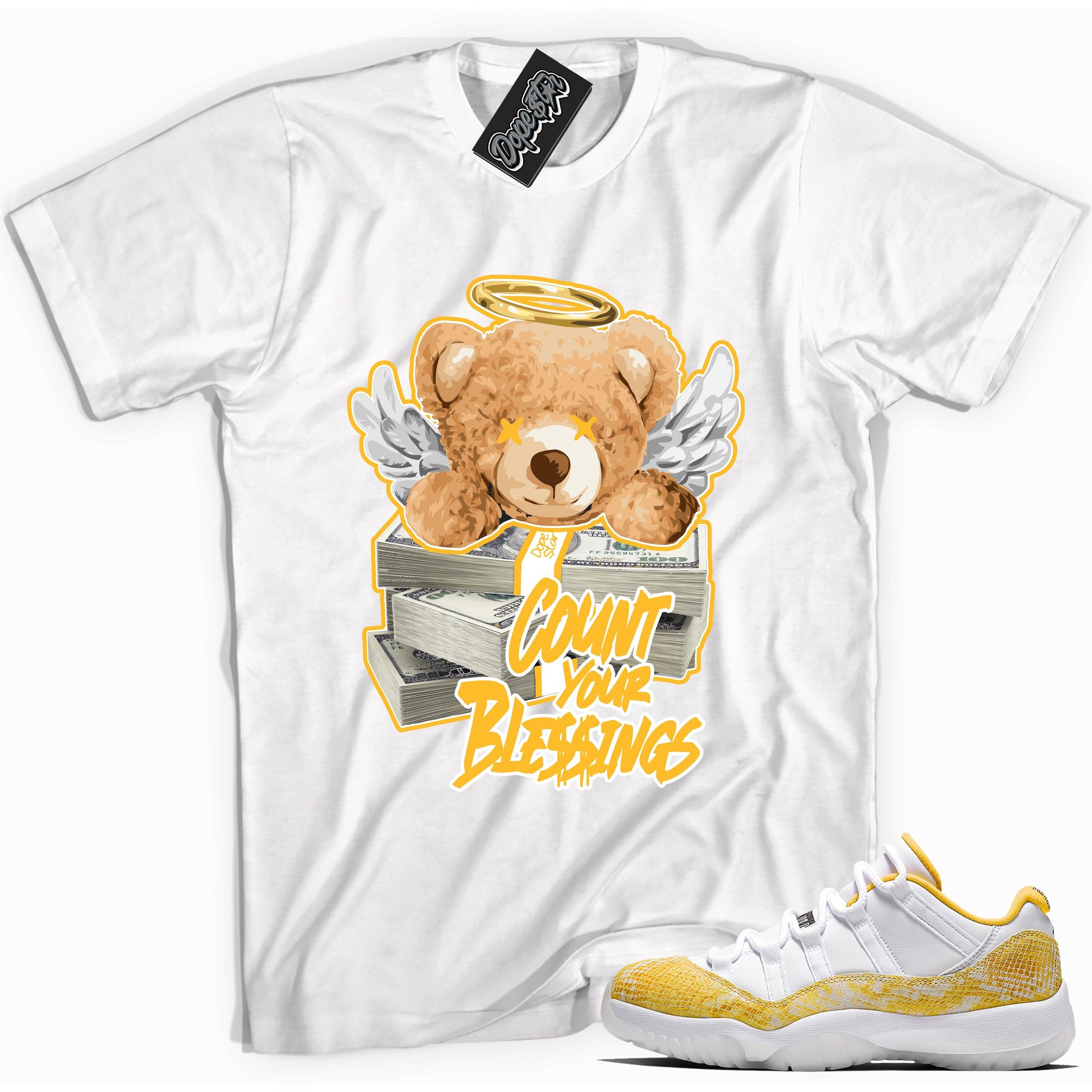 Cool white graphic tee with 'count your blessings' print, that perfectly matches Air Jordan 11 Low Yellow Snakeskin sneakers