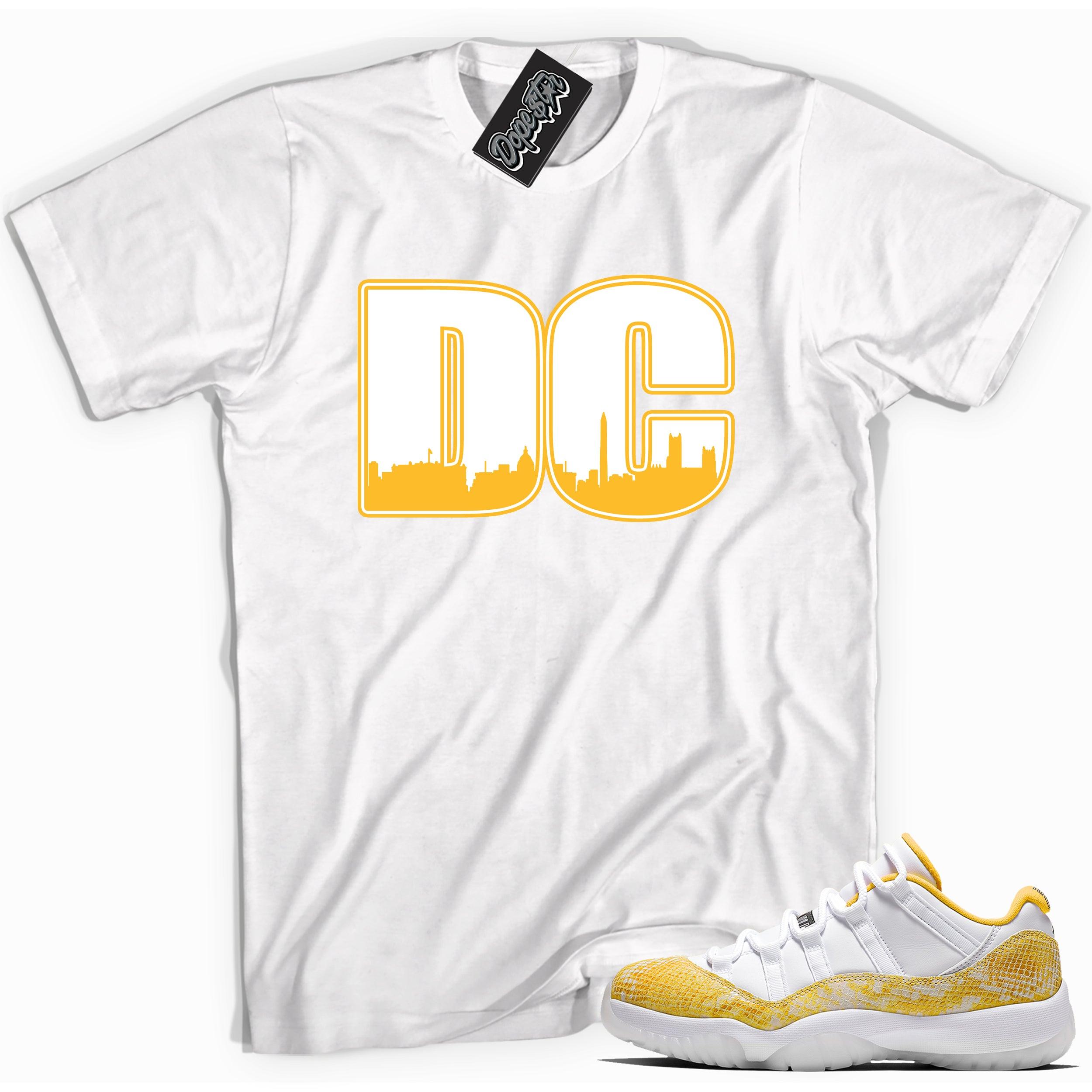 Cool white graphic tee with 'dc' print, that perfectly matches Air Jordan 11 Low Yellow Snakeskin sneakers