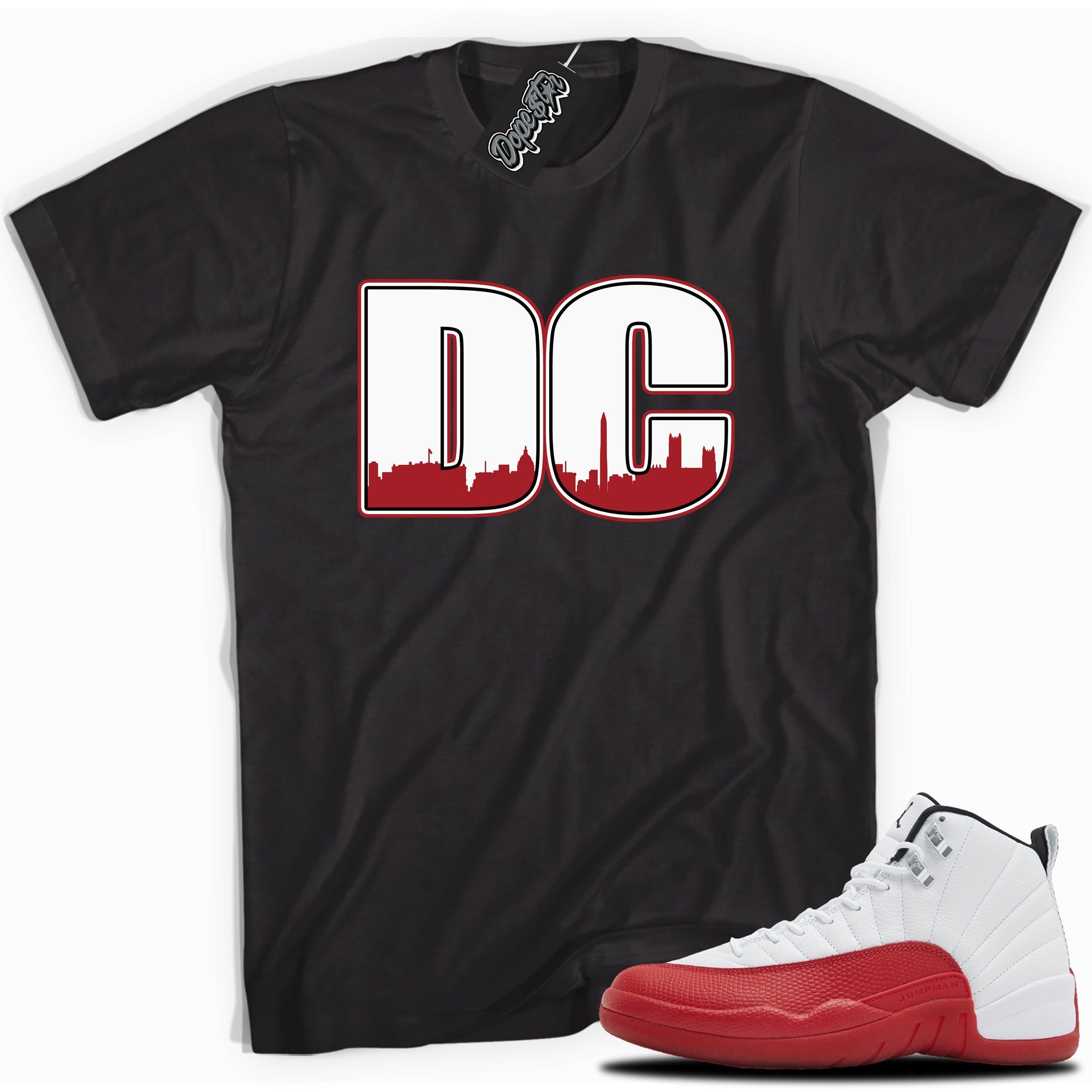 Cool Black graphic tee with “ DC ” print, that perfectly matches Air Jordan 12 Retro Cherry Red 2023 red and white sneakers 