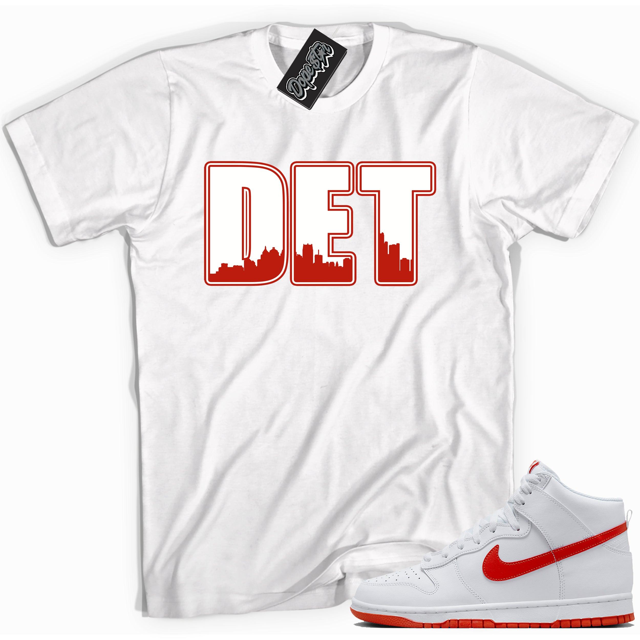Cool white graphic tee with 'Detroit' print, that perfectly matches Nike Dunk High White Picante Red sneakers.