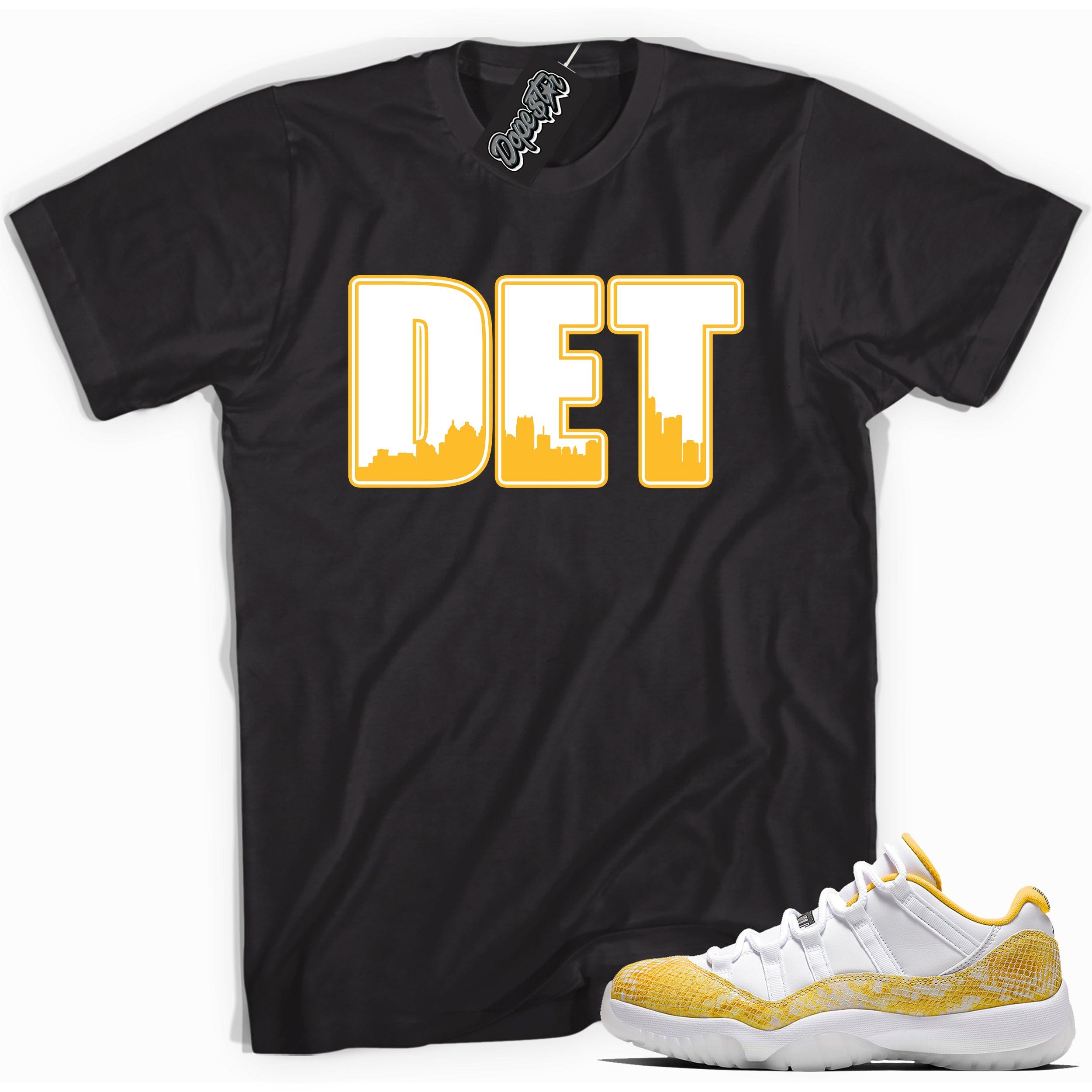 Cool black graphic tee with 'DET' print, that perfectly matches  Air Jordan 11 Low Yellow Snakeskin sneakers