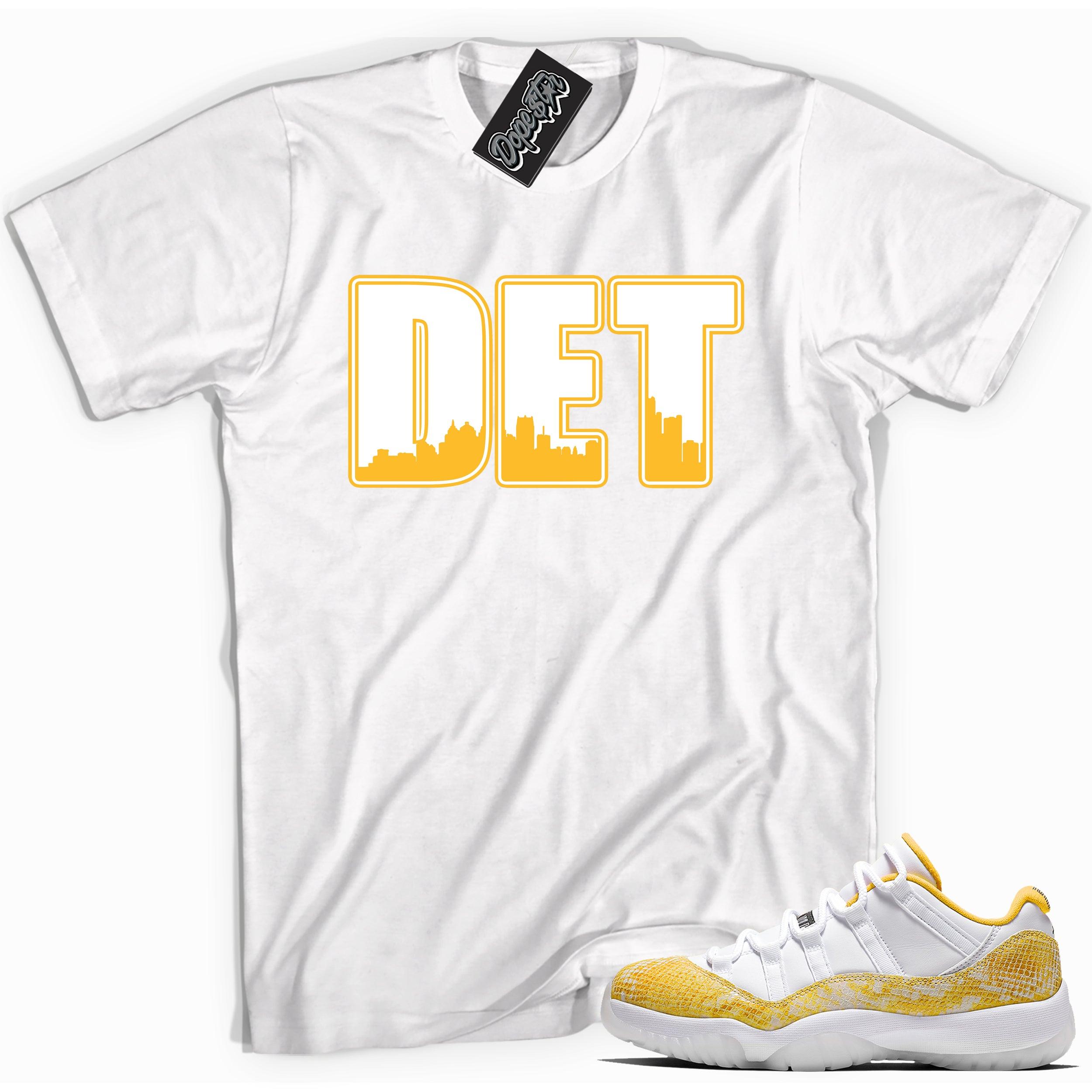 Cool white graphic tee with 'DET' print, that perfectly matches Air Jordan 11 Low Yellow Snakeskin sneakers