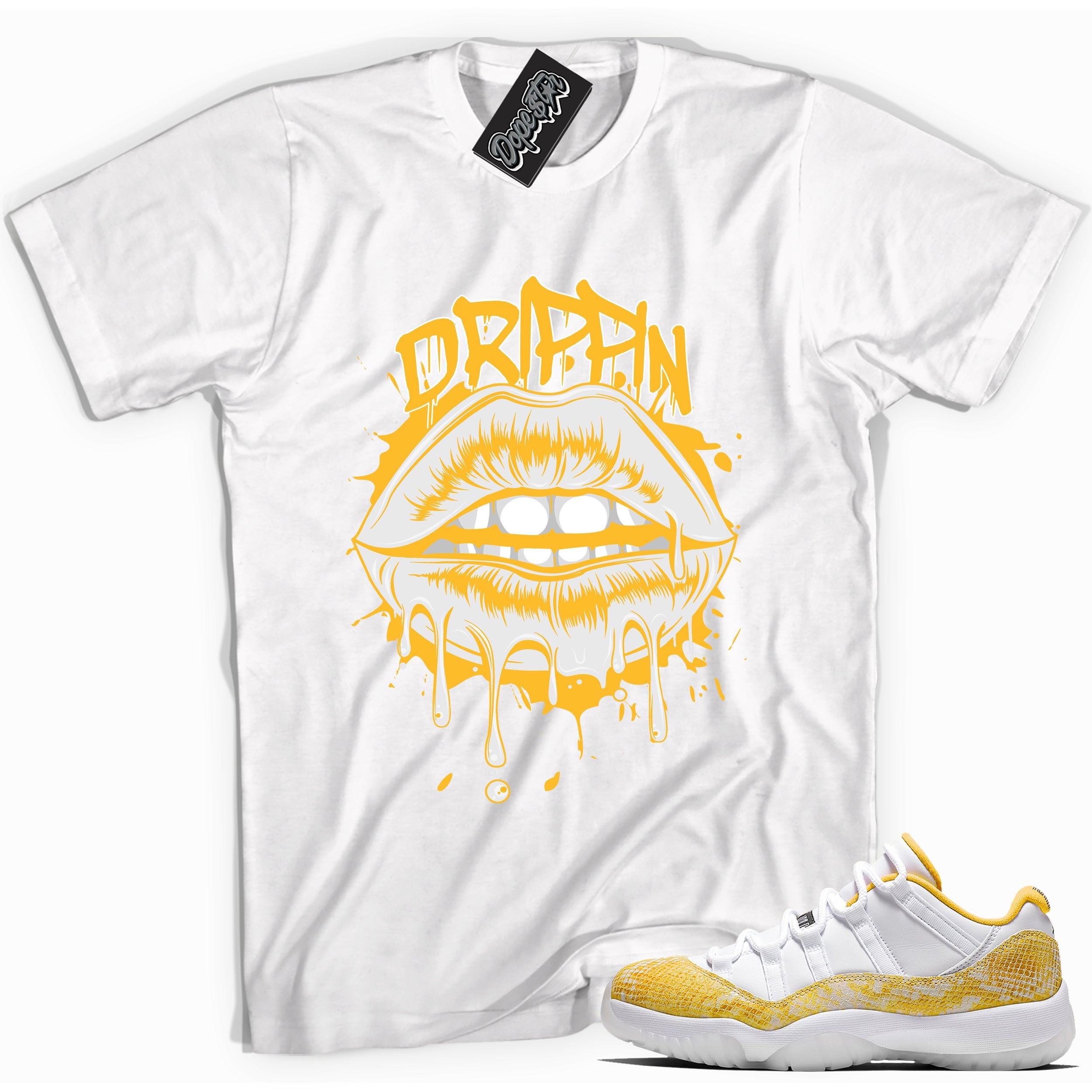 Cool white graphic tee with 'drippin' print, that perfectly matches Air Jordan 11 Low Yellow Snakeskin sneakers