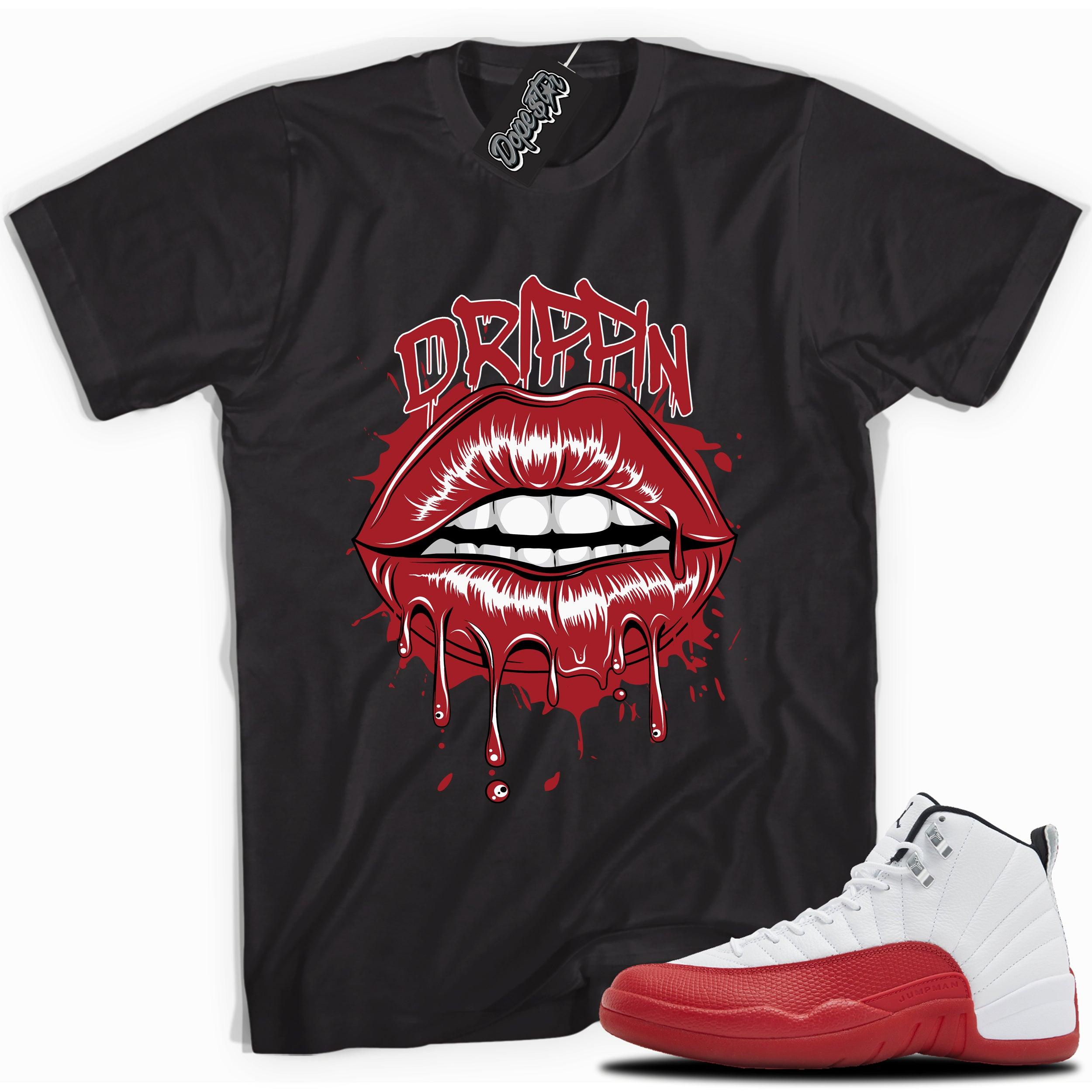 Cool Black graphic tee with “ DRIPPIN ” print, that perfectly matches Air Jordan 12 Retro Cherry Red 2023 red and white sneakers