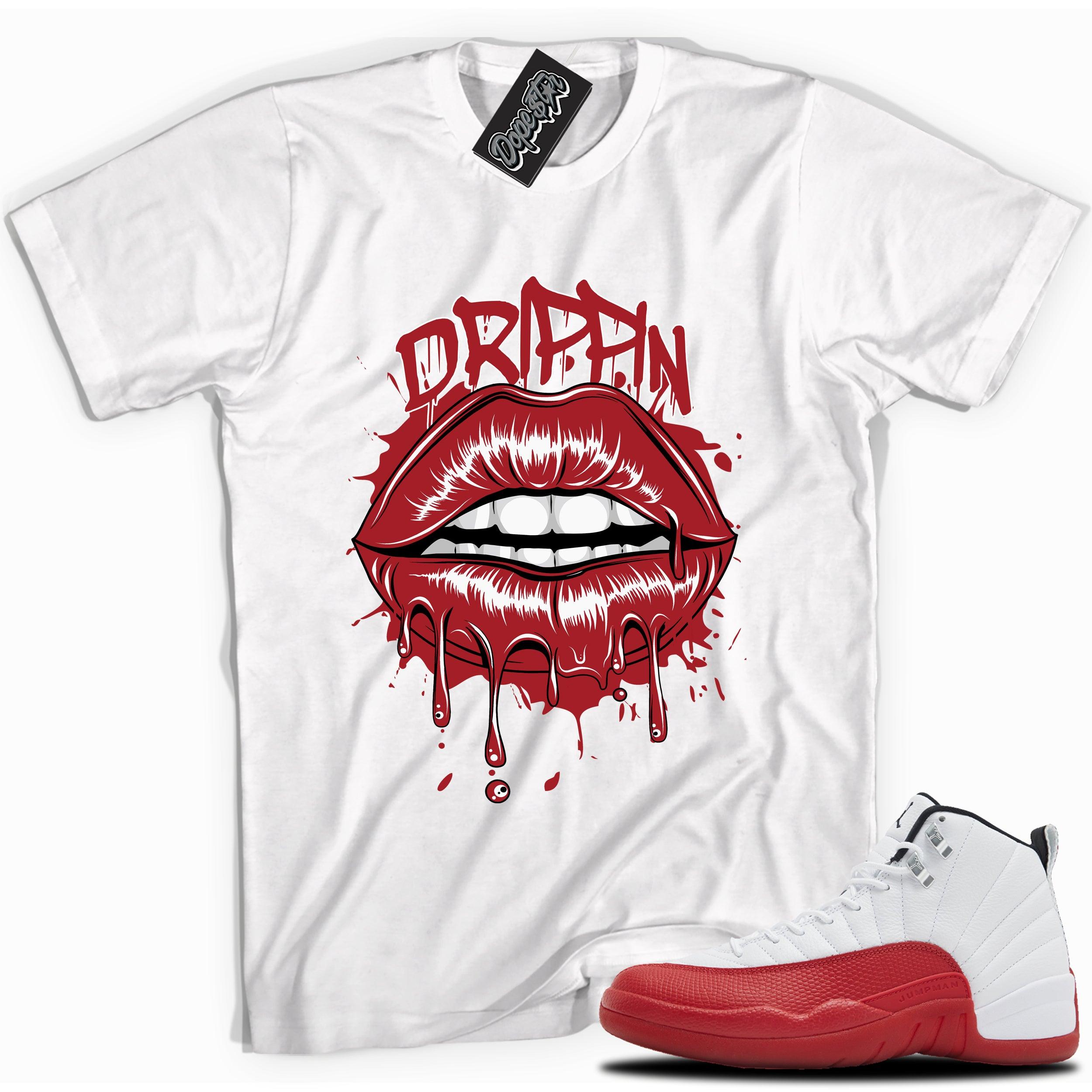 Cool White graphic tee with “ DRIPPIN ” print, that perfectly matches Air Jordan 12 Retro Cherry Red 2023 red and white sneakers