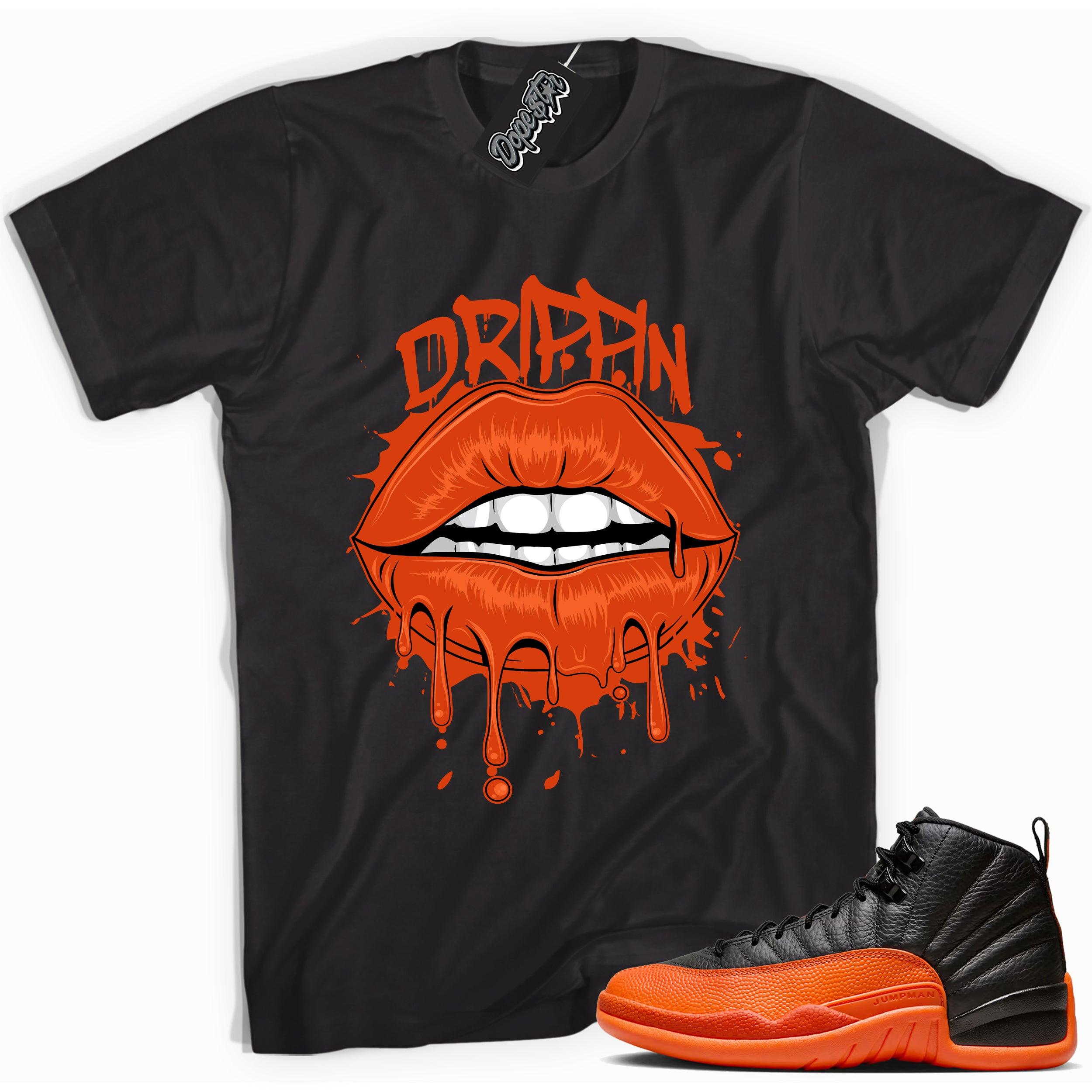 Cool Black graphic tee with “ Drippin Lips ” print, that perfectly matches Air Jordan 12 Retro WNBA All-Star Brilliant Orange sneakers 