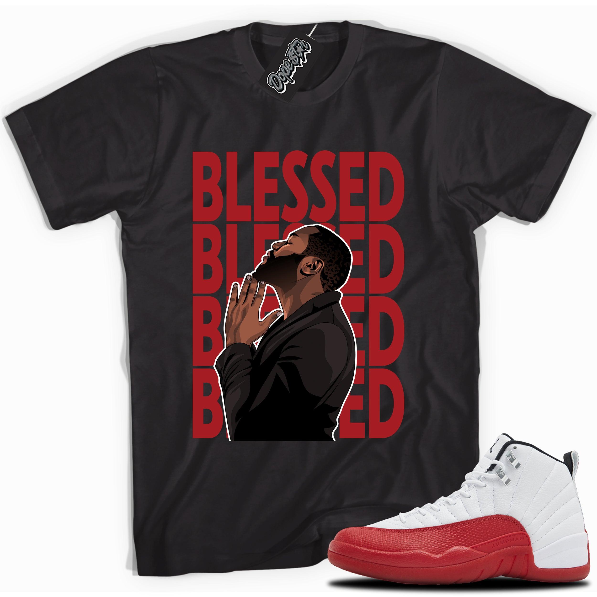 Cool Black graphic tee with “ GOD BLESSED ” print, that perfectly matches Air Jordan 12 Retro Cherry Red 2023 red and white sneakers 
