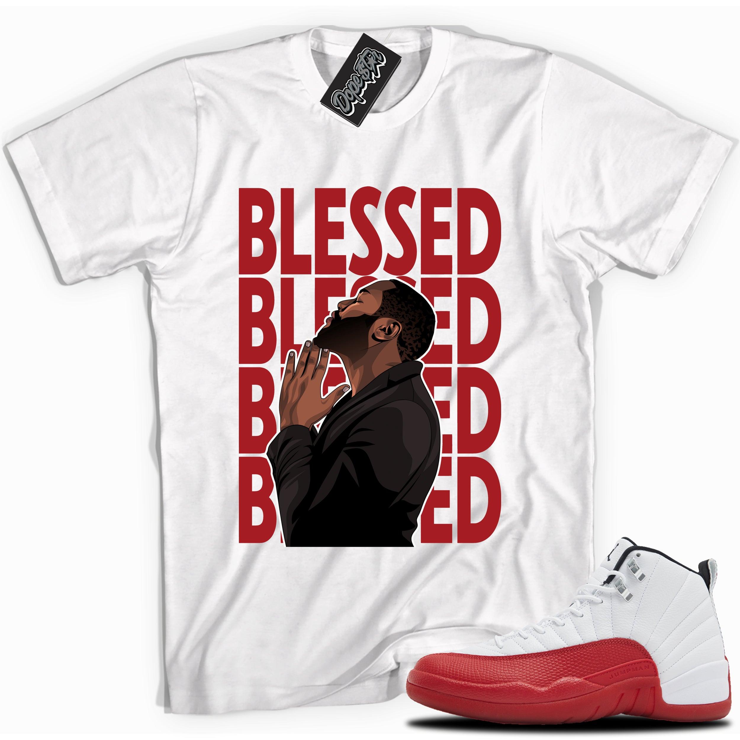 Cool White graphic tee with “ GOD BLESSED ” print, that perfectly matches Air Jordan 12 Retro Cherry Red 2023 red and white sneakers 