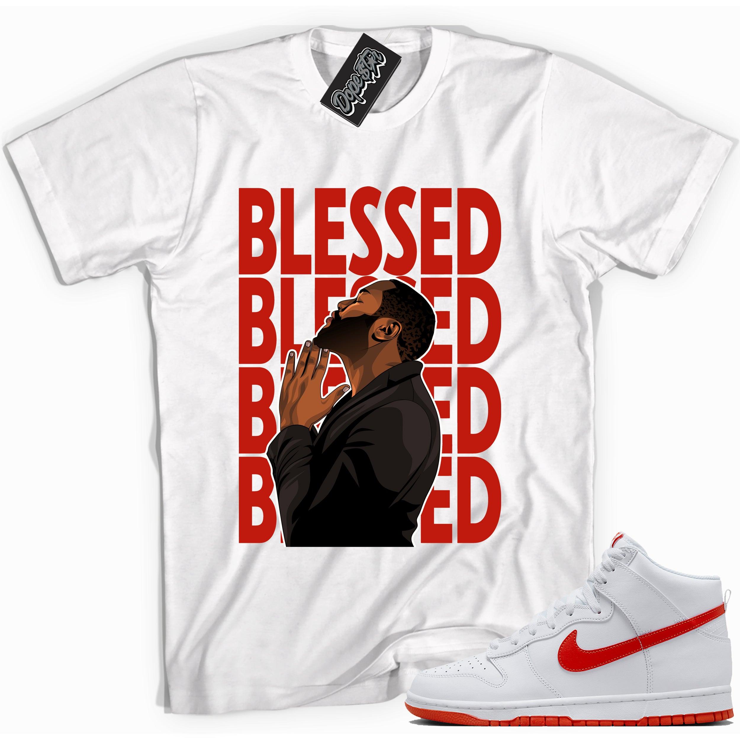 Cool white graphic tee with 'god blessed' print, that perfectly matches Nike Dunk High White Picante Red sneakers.