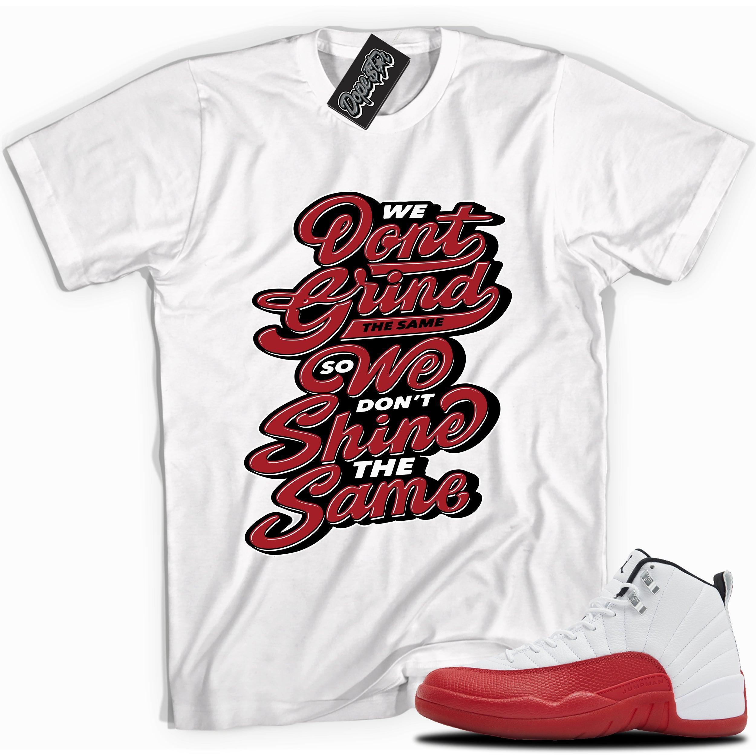 Cool White graphic tee with “ Grind Shine ” print, that perfectly matches Air Jordan 12 Retro Cherry Red 2023 red and white sneakers