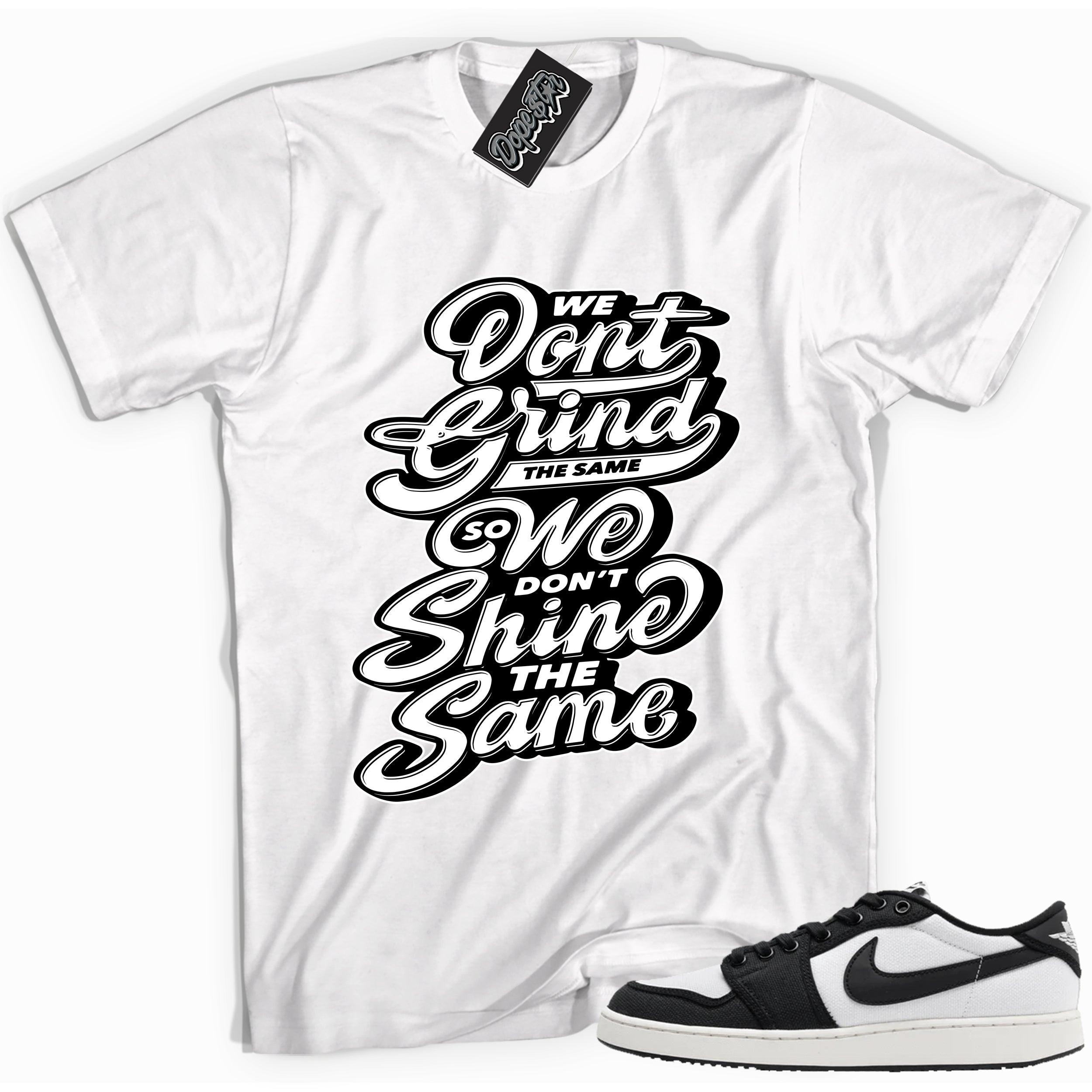 Cool white graphic tee with 'we don't grind the same' print, that perfectly matches Air Jordan 1 Retro Ajko Low Black & White sneakers.