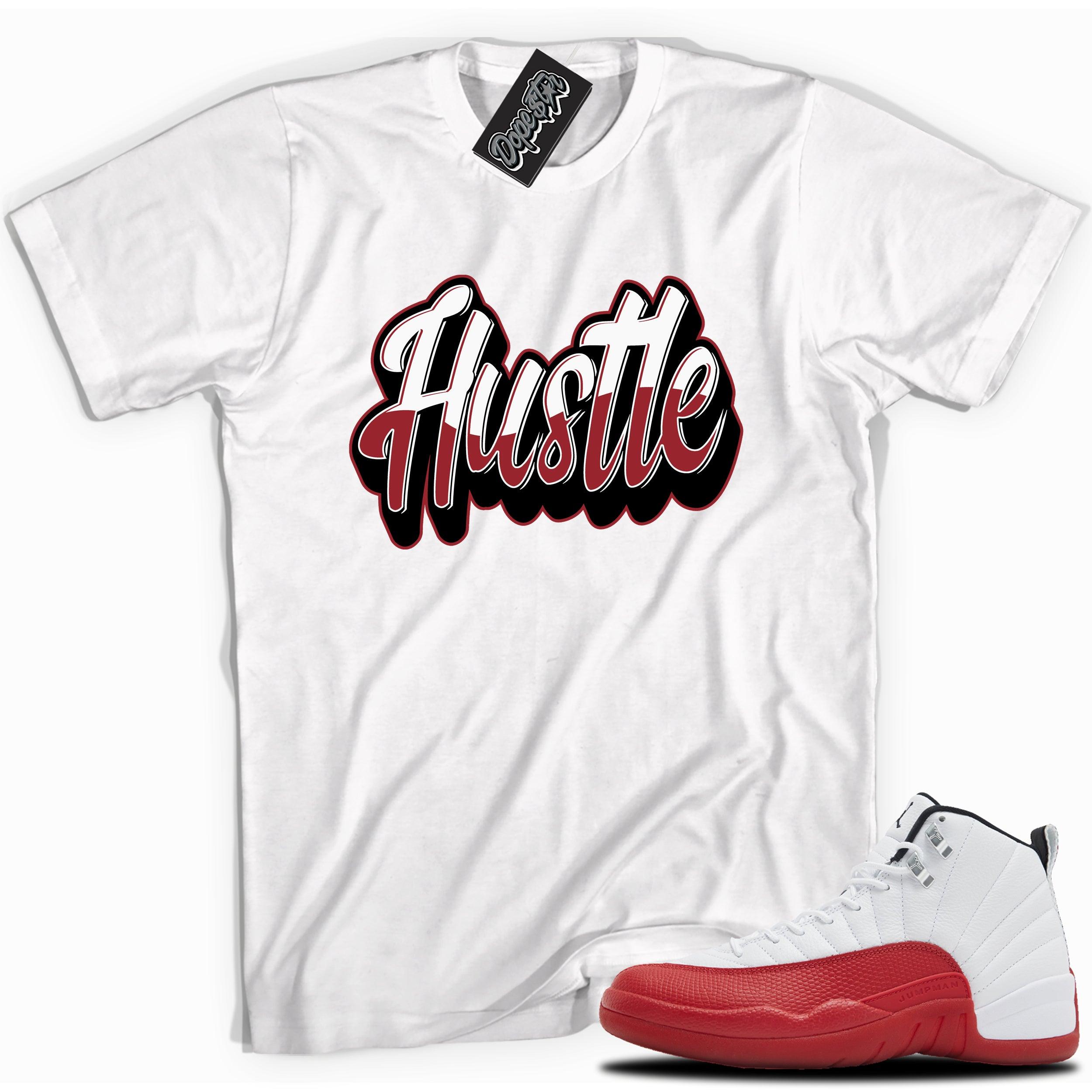 Cool White graphic tee with “ HUSTLE 2 ” print, that perfectly matches Air Jordan 12 Retro Cherry Red 2023 red and white sneakers 