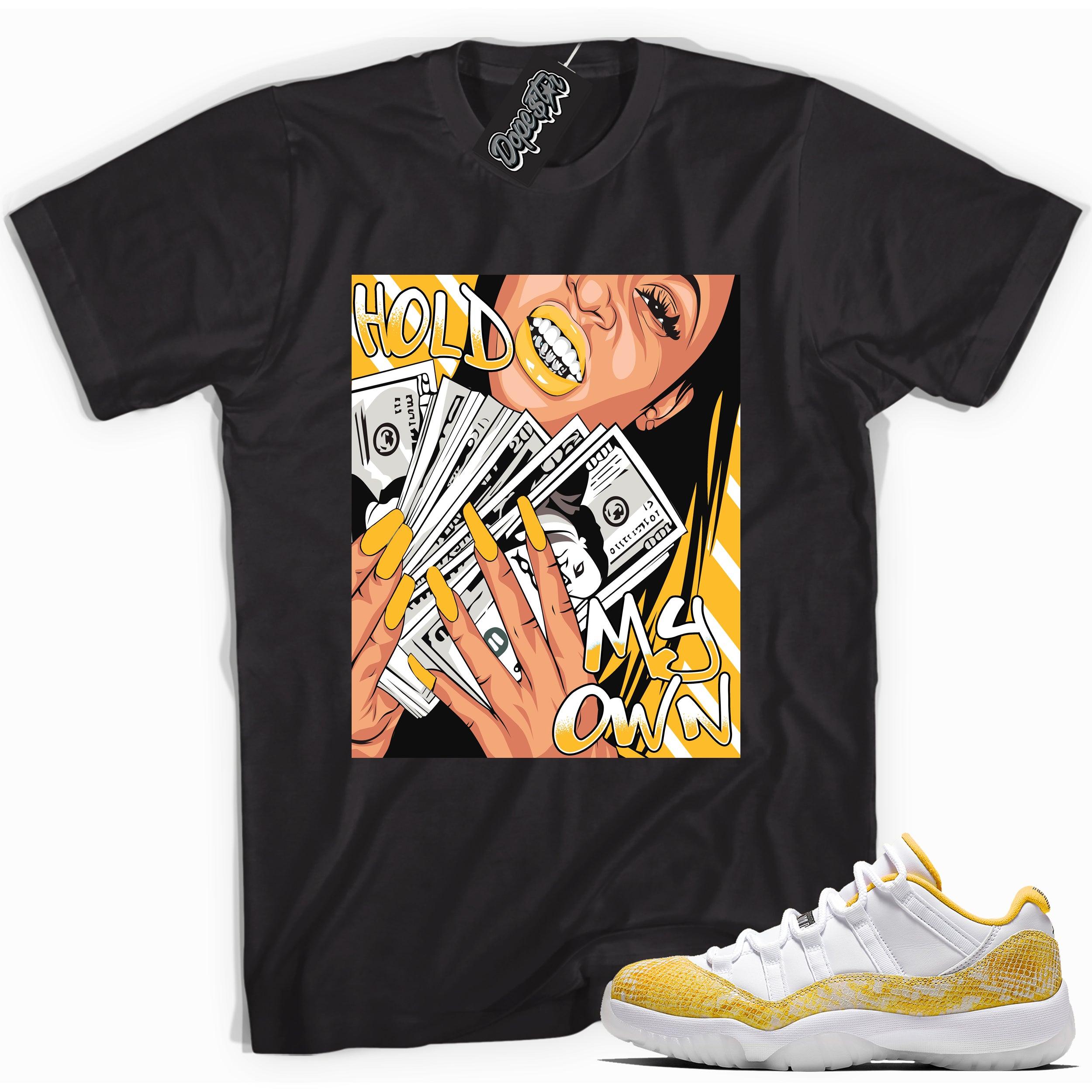 Cool black graphic tee with 'hold my own' print, that perfectly matches  Air Jordan 11 Low Yellow Snakeskin sneakers