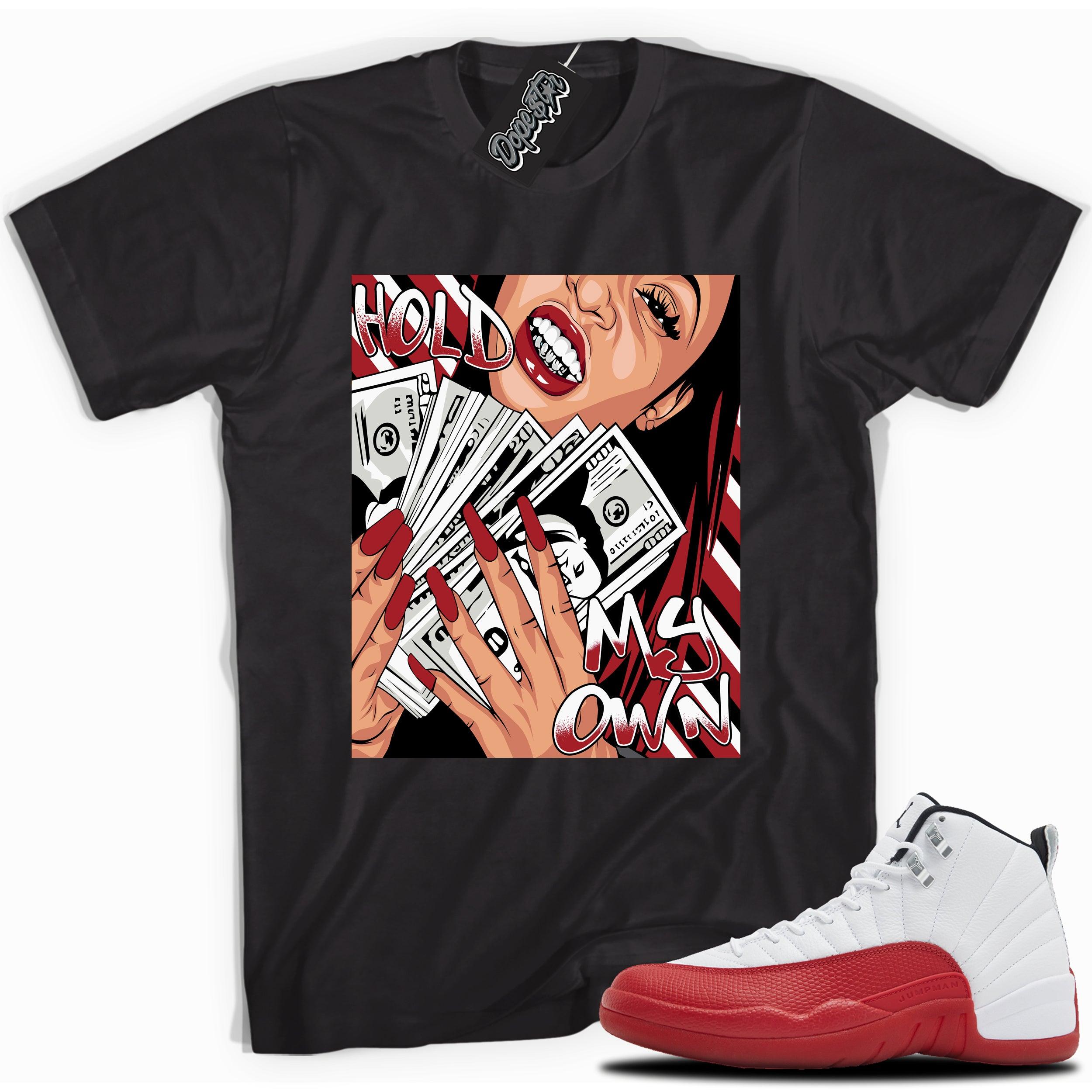 Cool Black graphic tee with “ Hold My Own ” print, that perfectly matches Air Jordan 12 Retro Cherry Red 2023 red and white sneakers