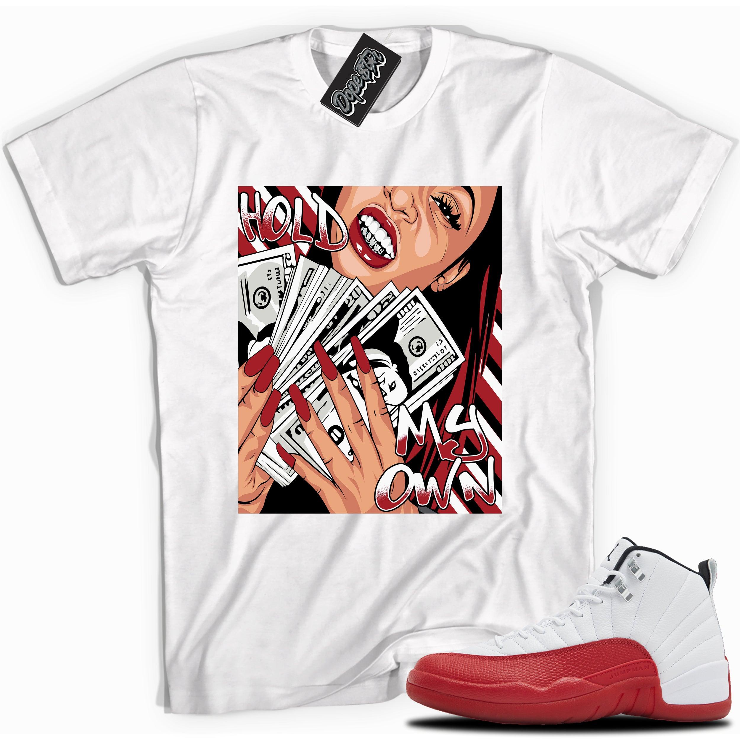 Cool White graphic tee with “ Hold My Own ” print, that perfectly matches Air Jordan 12 Retro Cherry Red 2023 red and white sneakers