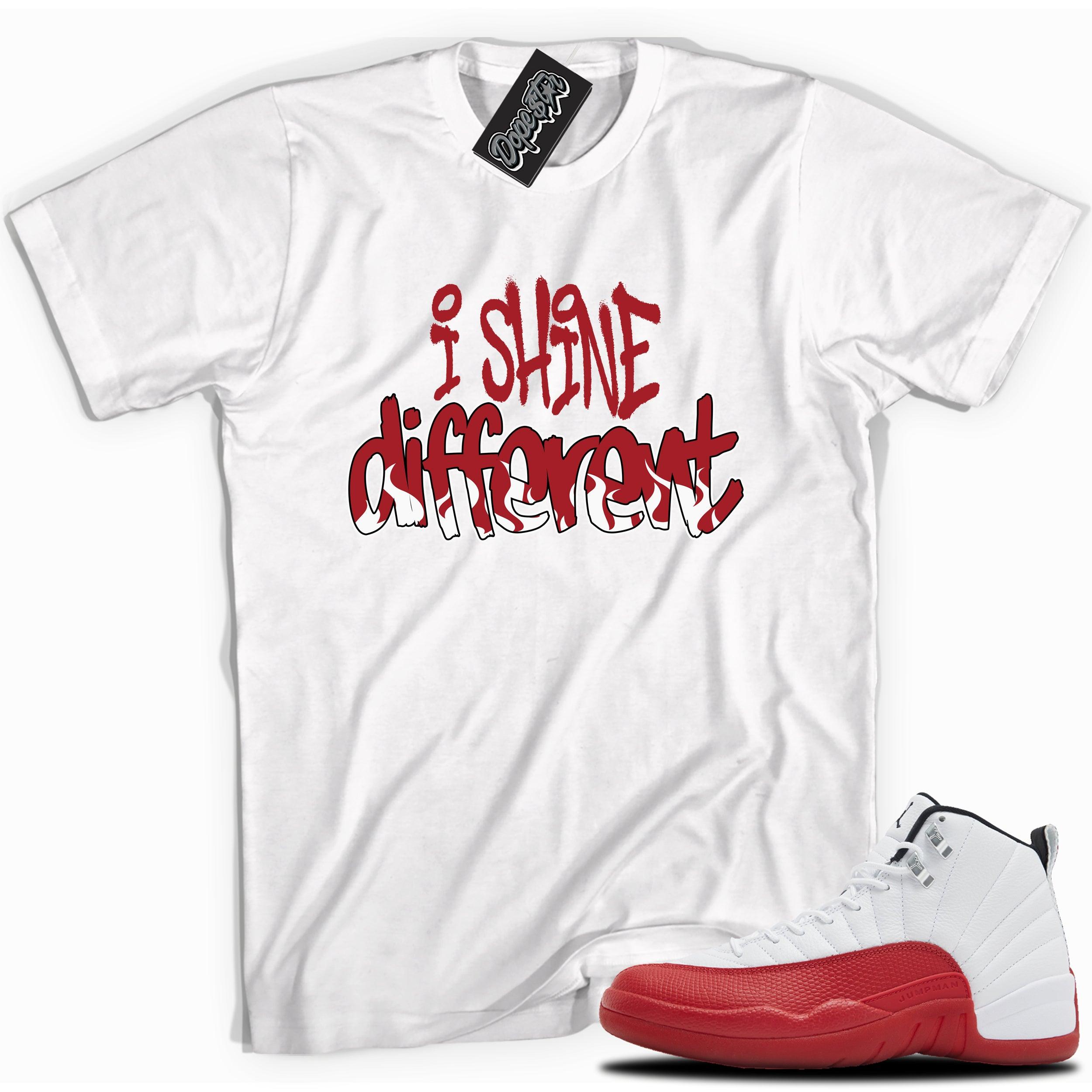 Cool White graphic tee with “  I SHINE DIFFERENT ” print, that perfectly matches Air Jordan 12 Retro Cherry Red 2023 red and white sneakers 