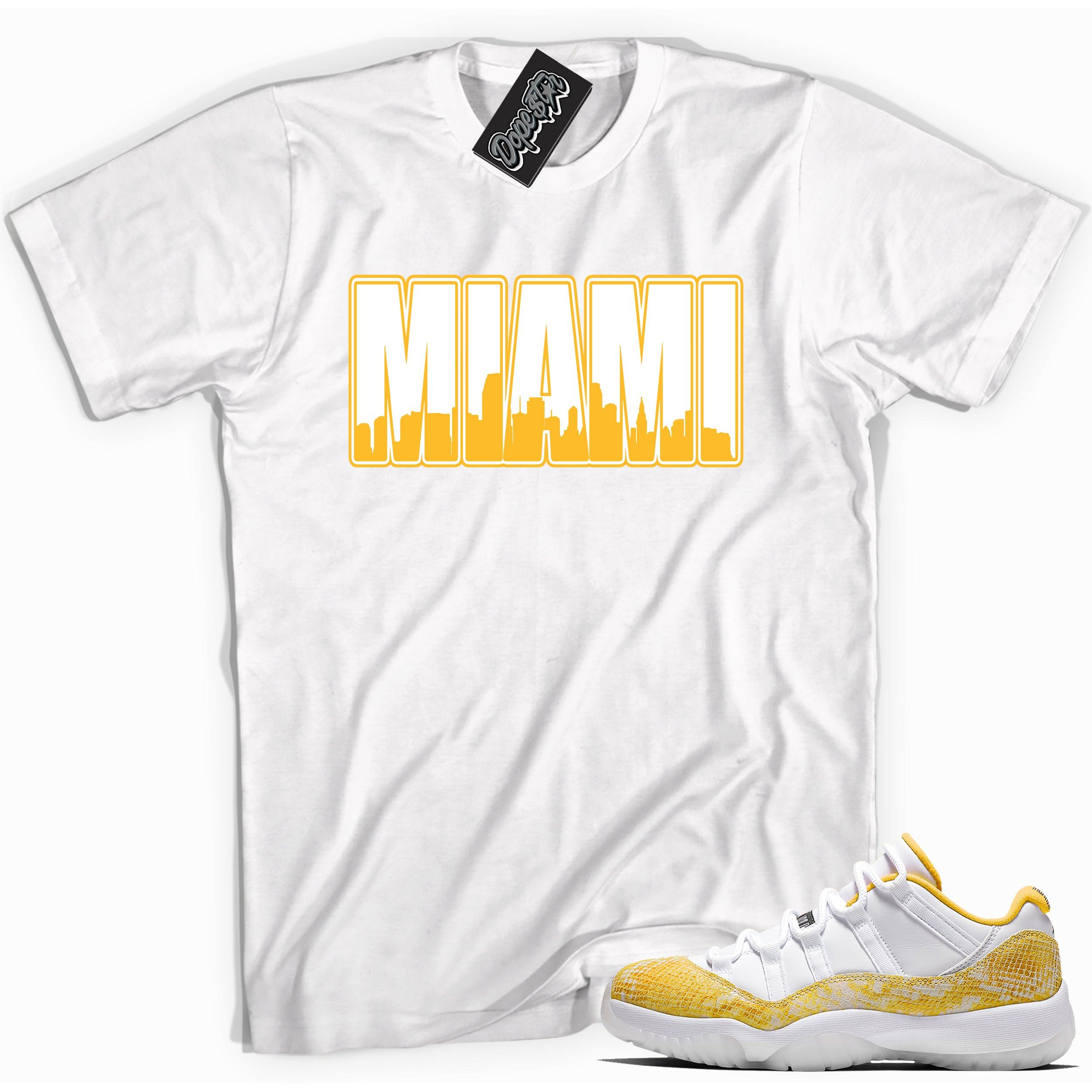 Cool white graphic tee with 'miami' print, that perfectly matches Air Jordan 11 Low Yellow Snakeskin sneakers