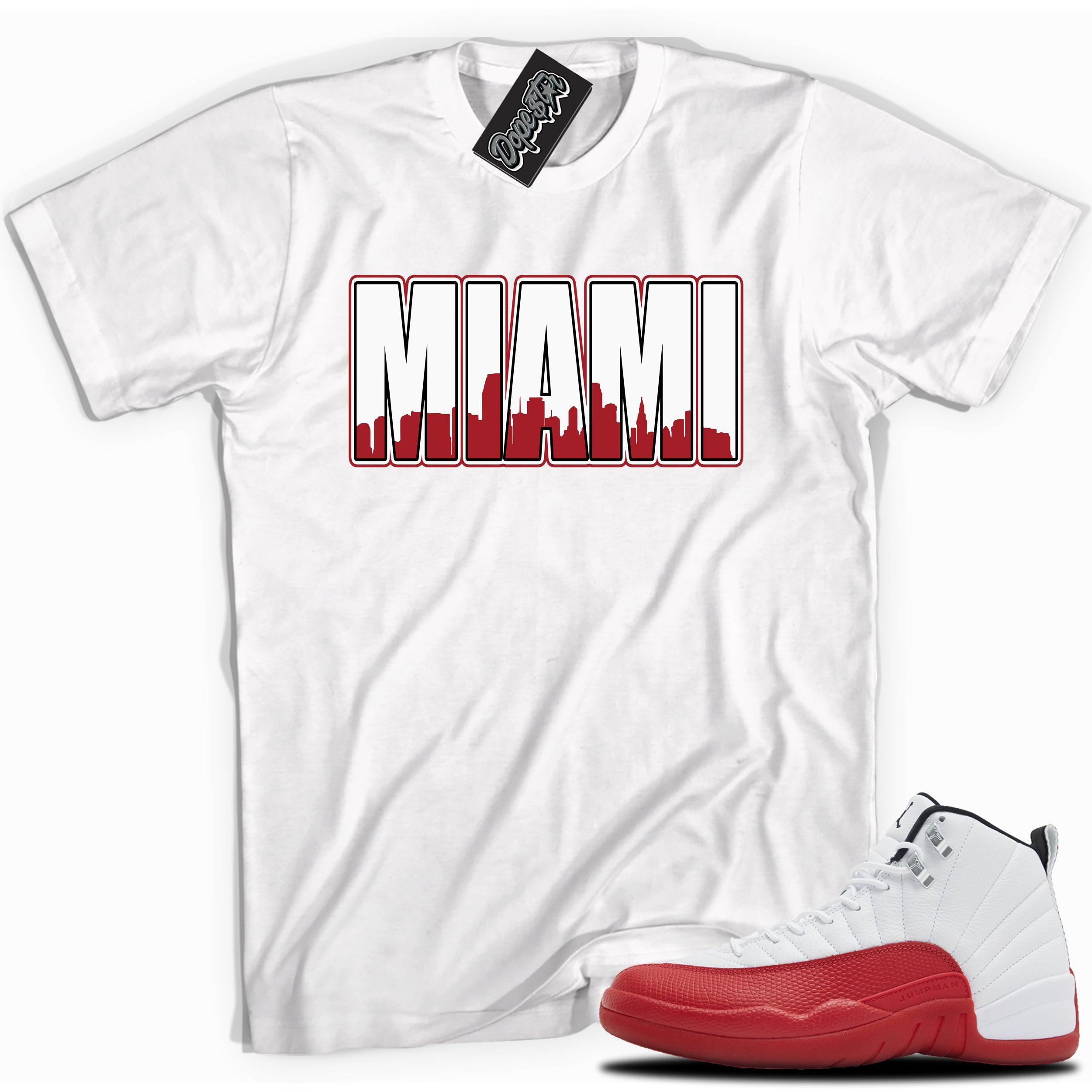 Cool White graphic tee with “ MIAMI ” print, that perfectly matches Air Jordan 12 Retro Cherry Red 2023 red and white sneakers 