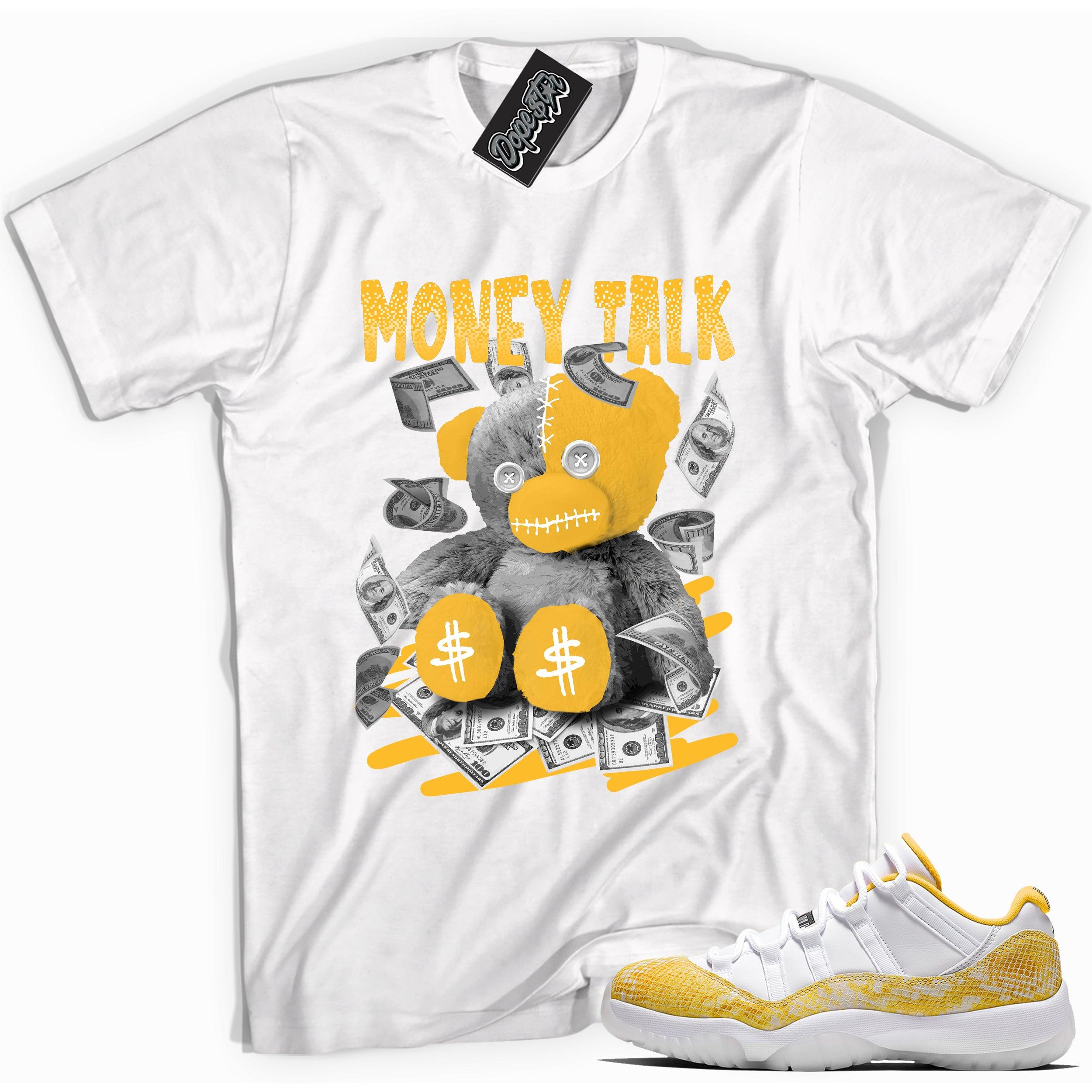 Cool white graphic tee with 'money talk bear' print, that perfectly matches Air Jordan 11 Retro Low Yellow Snakeskin sneakers