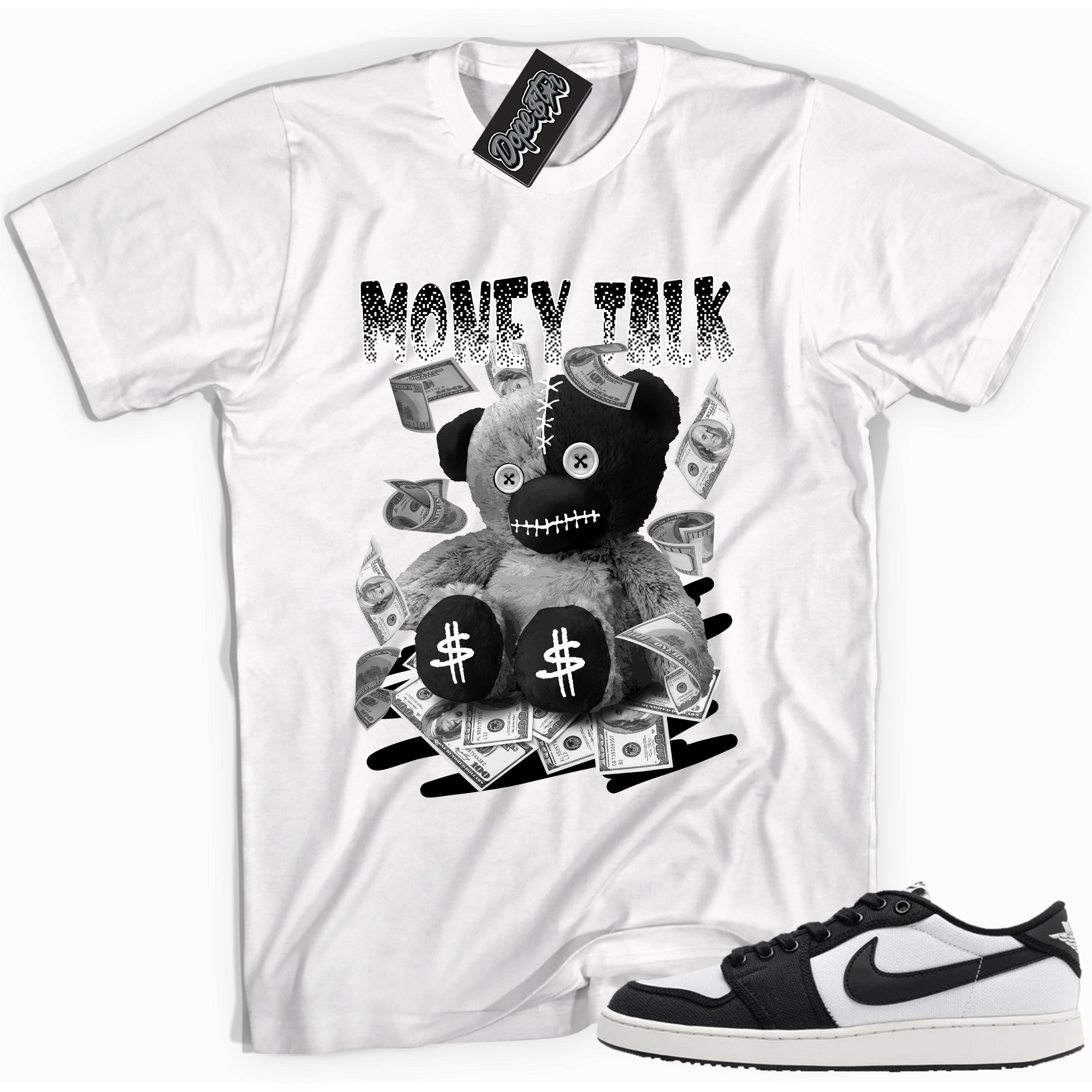 Cool white graphic tee with 'money talk bear' print, that perfectly matches Air Jordan 1 Retro Ajko Low Black & White sneakers.