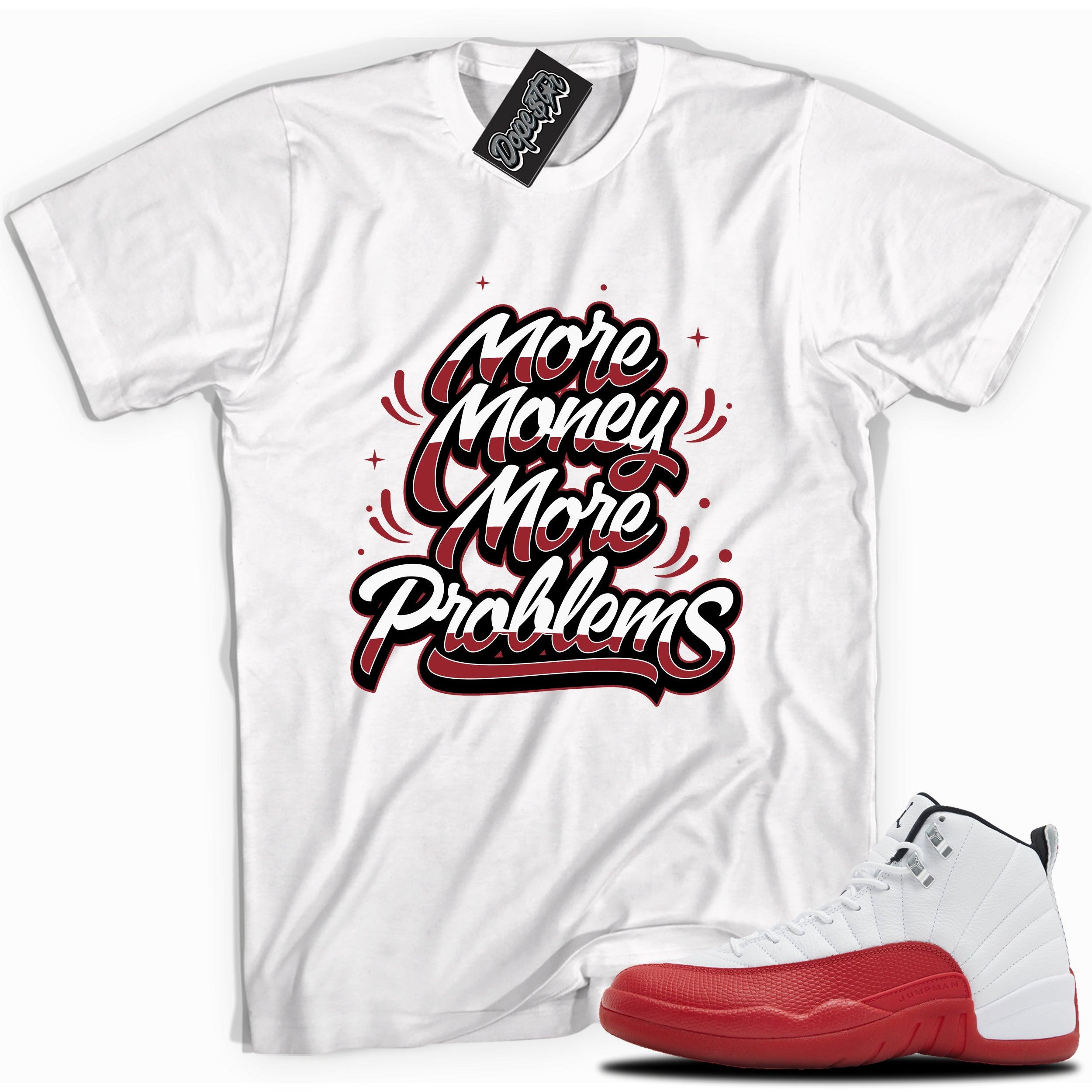 Cool White graphic tee with “MORE MONEY MORE PROBLEMS” print, that perfectly matches Air Jordan 12 Retro Cherry Red 2023 red and white sneakers 