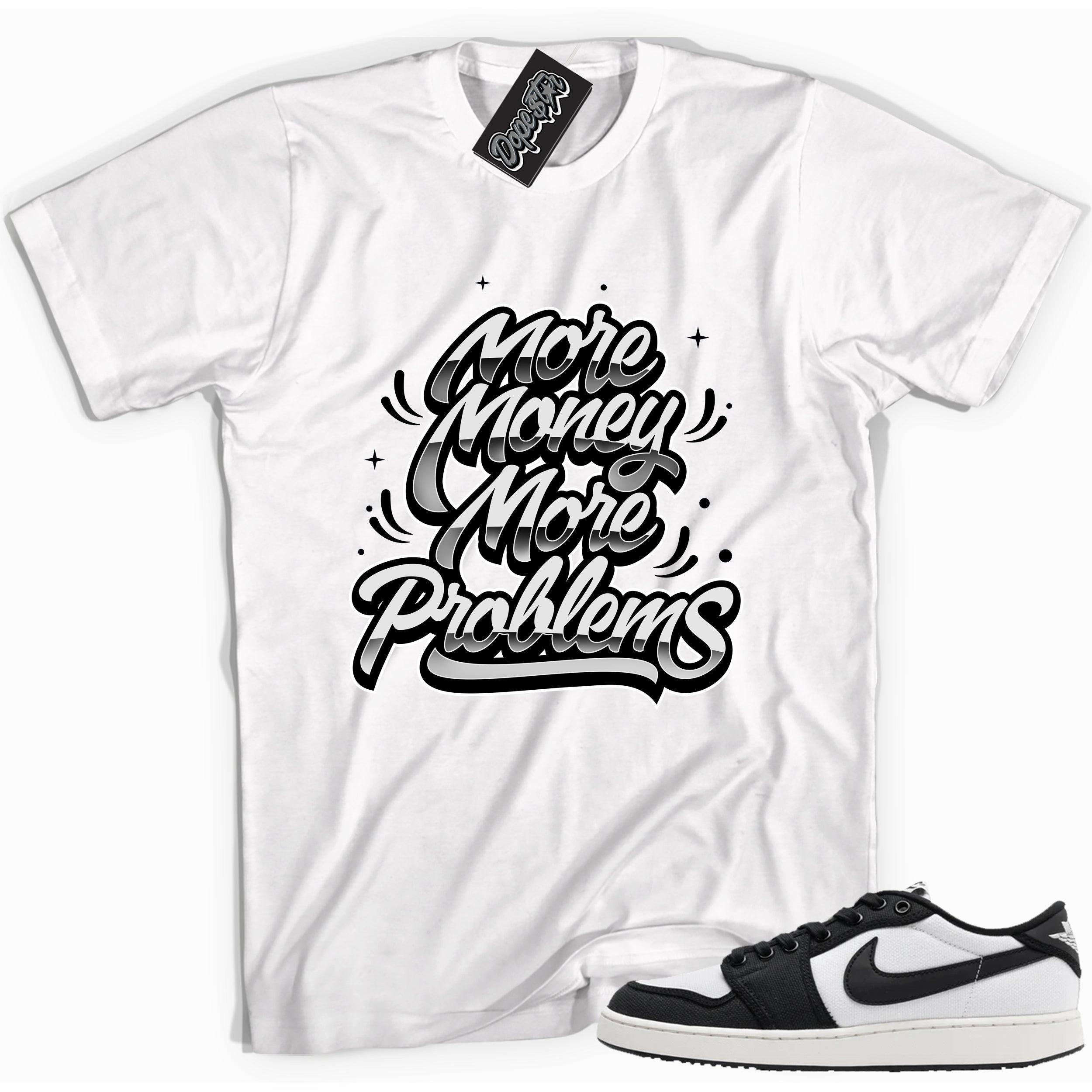 Cool white graphic tee with 'more money more problems' print, that perfectly matches Air Jordan 1 Retro Ajko Low Black & White sneakers.
