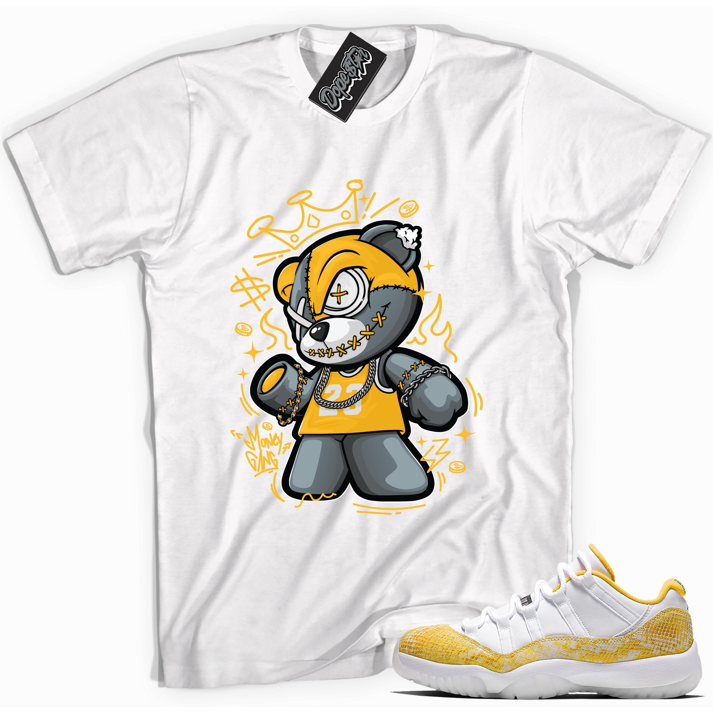 Cool white graphic tee with 'money gang bear' print, that perfectly matches Air Jordan 11 Retro Low Yellow Snakeskin sneakers