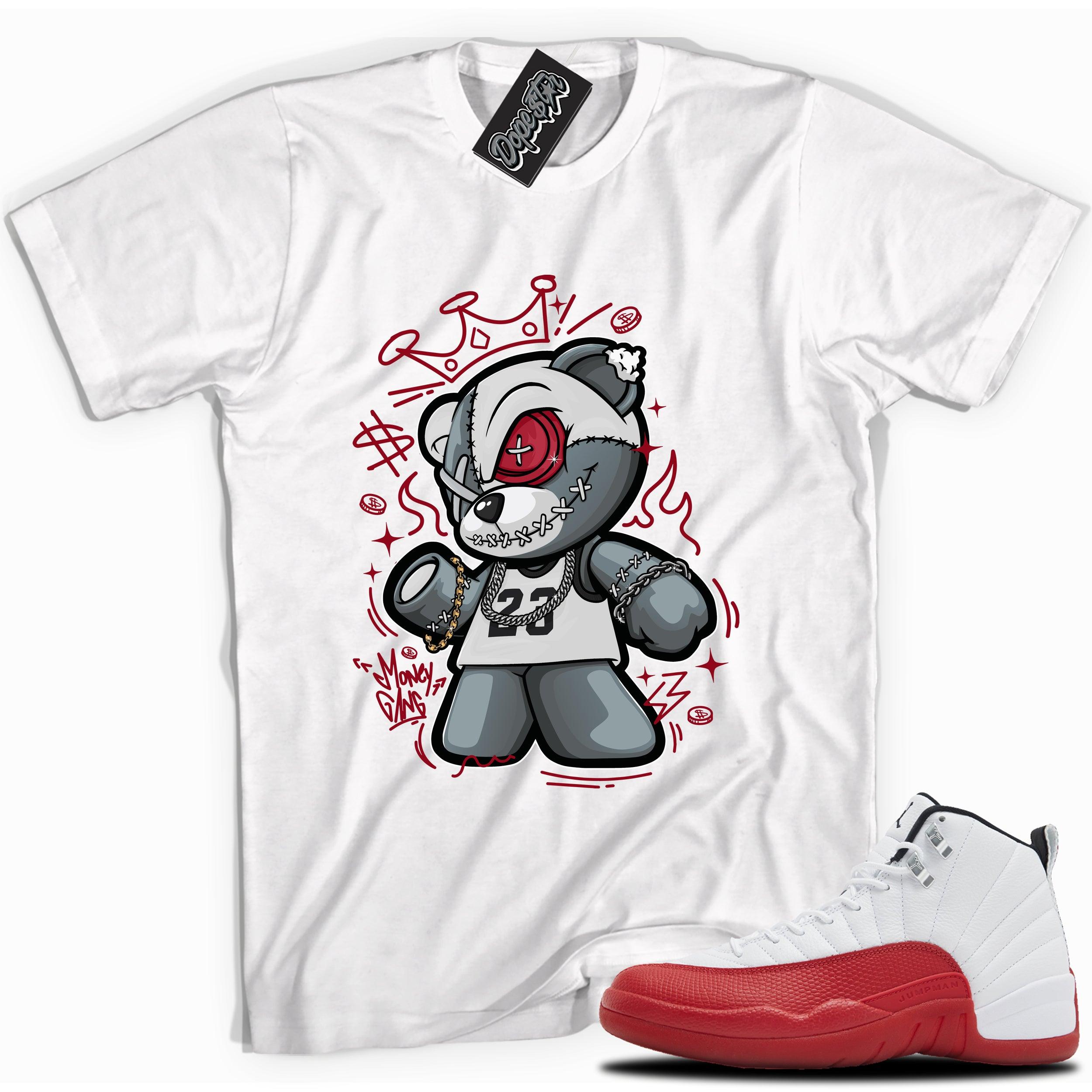 Cool White graphic tee with “ Money Gang Bear ” print, that perfectly matches Air Jordan 12 Retro Cherry Red 2023 red and white sneakers 