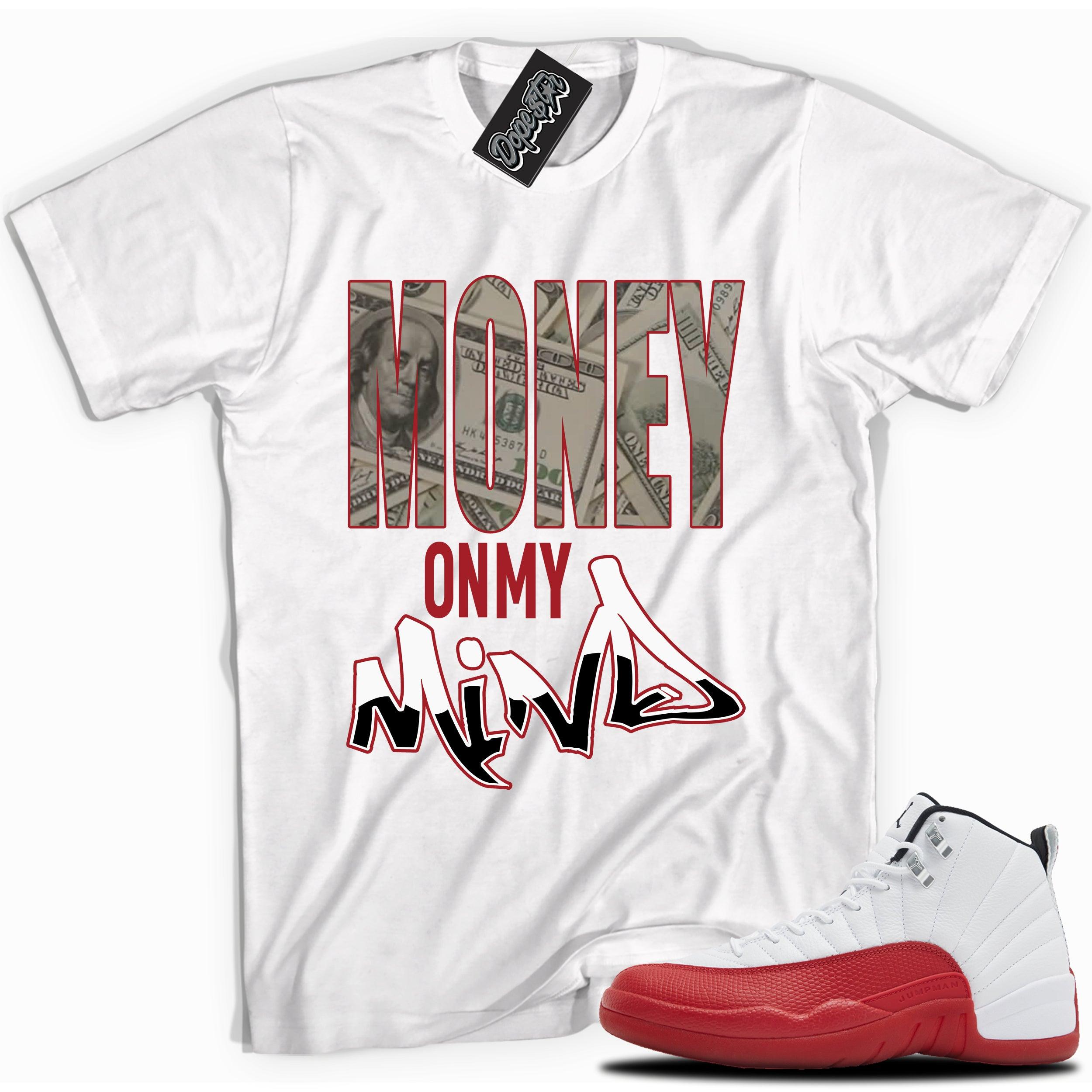 Cool White graphic tee with “  Money On My Mind  ” print, that perfectly matches Air Jordan 12 Retro Cherry Red 2023 red and white sneakers 