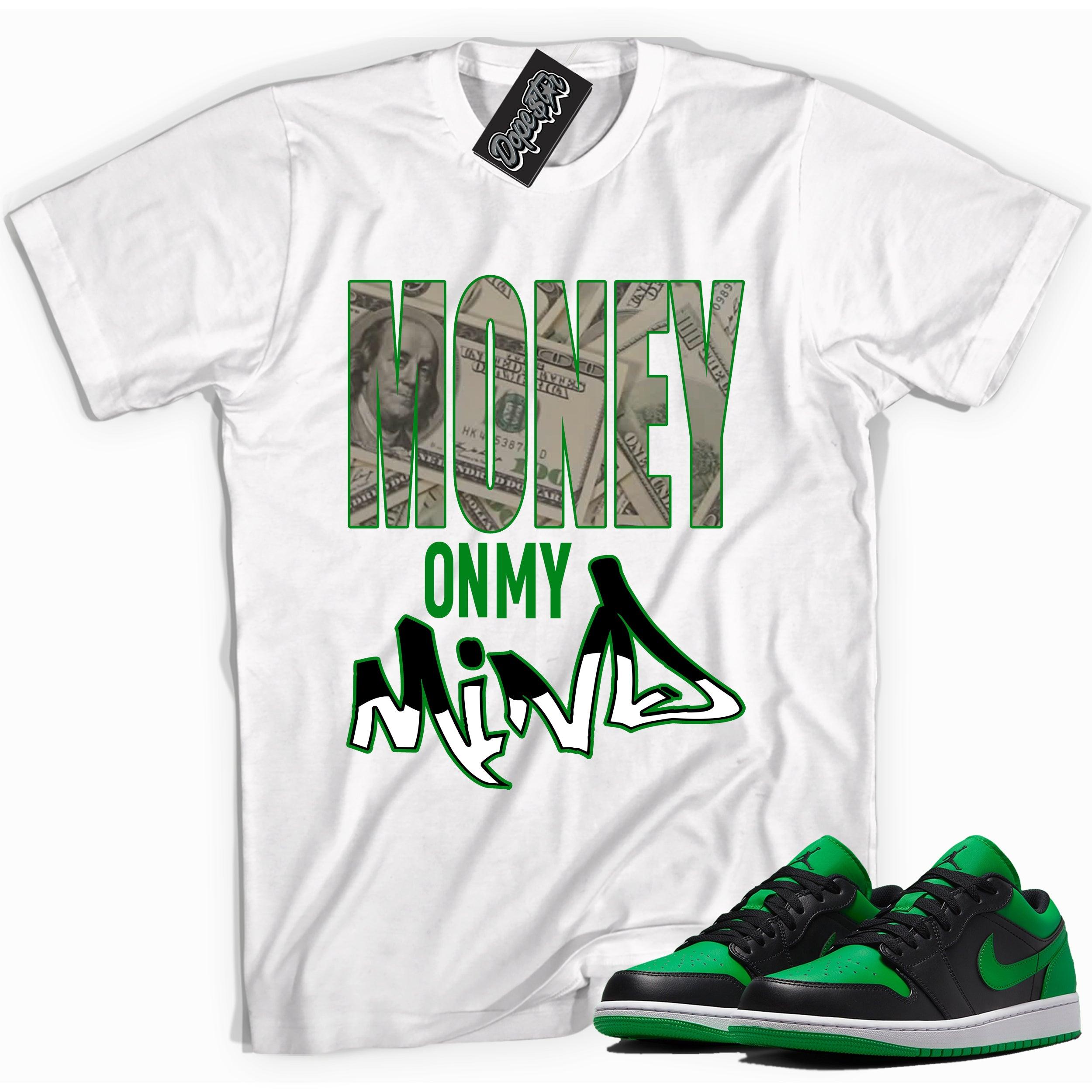 Cool white graphic tee with 'money on my mind' print, that perfectly matches Air Jordan 1 Low Lucky Green sneakers
