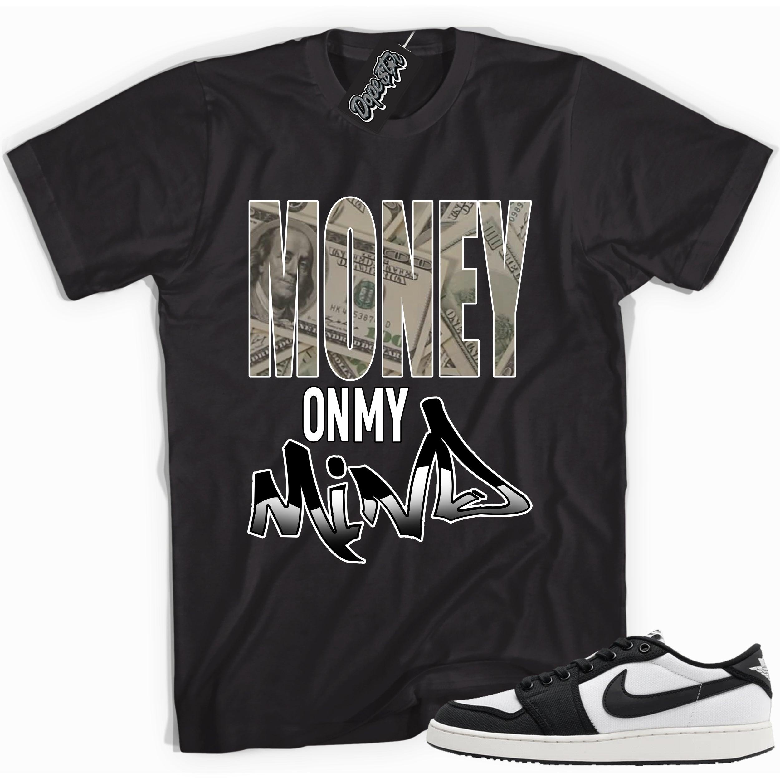 Cool black graphic tee with 'money on my mind' print, that perfectly matches Air Jordan 1 Retro Ajko Low Black & White sneakers.