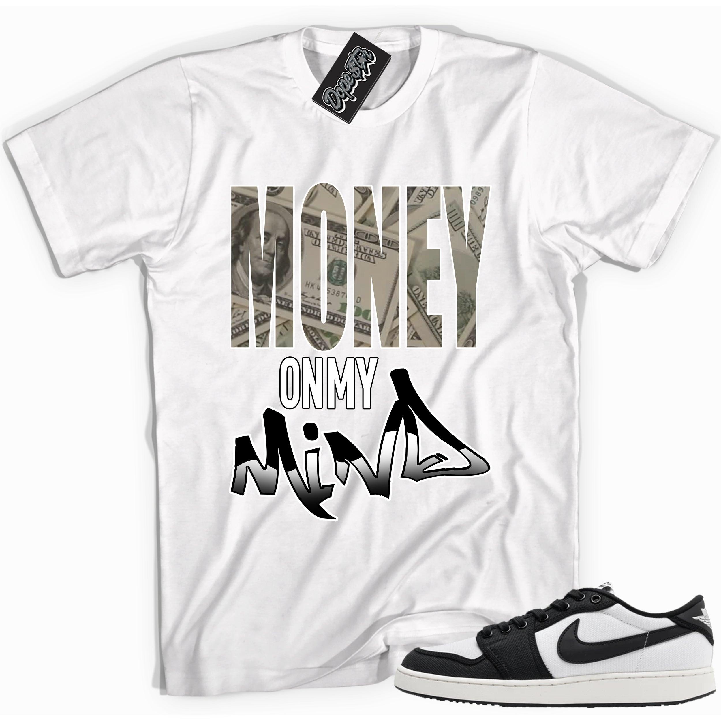 Cool white graphic tee with 'money on my mind' print, that perfectly matches Air Jordan 1 Retro Ajko Low Black & White sneakers.