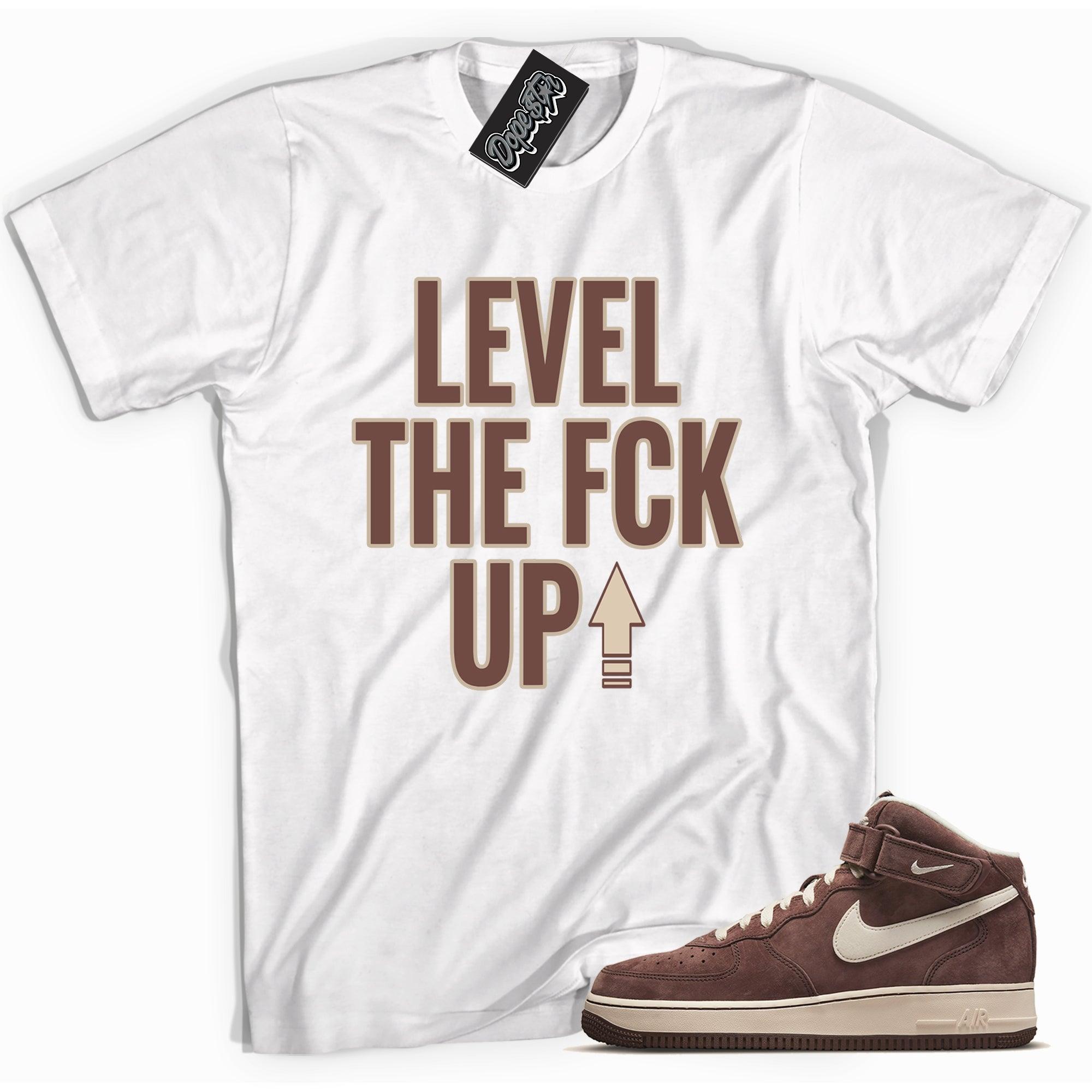 Cool white graphic tee with 'Level Up' print, that perfectly matches Nike Air Force 1 Mid QS Chocolate sneakers.